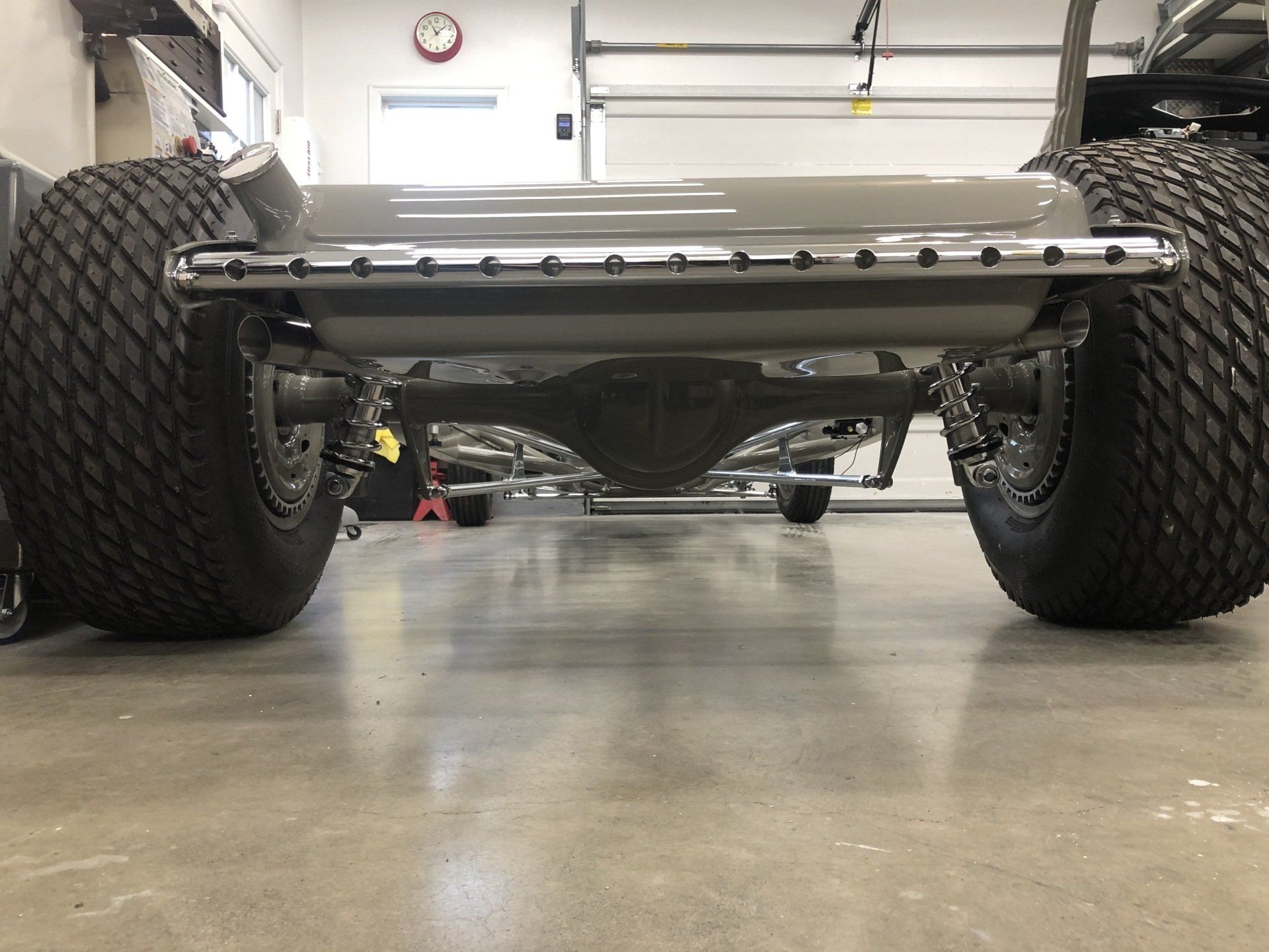 A car is sitting on a concrete floor in a garage.