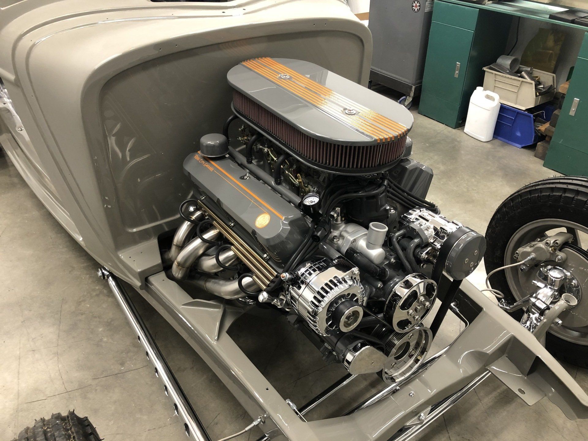 A close up of a car engine in a garage.