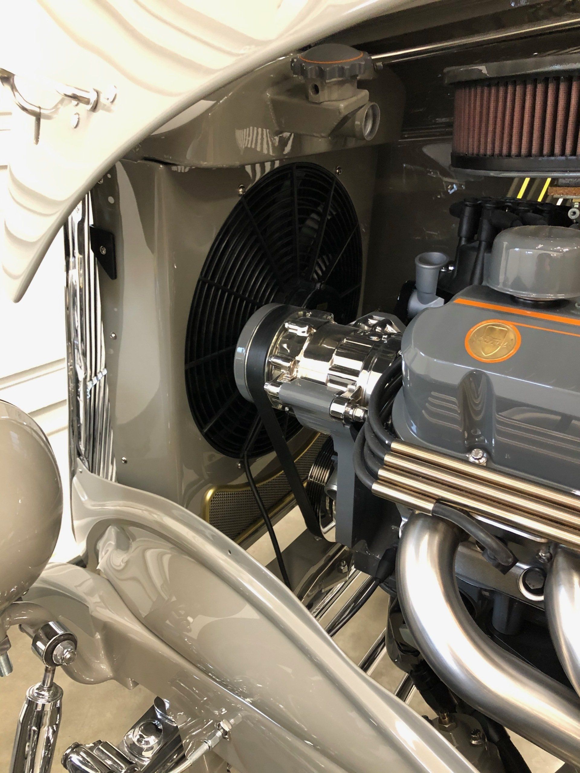 A close up of a car engine with a fan