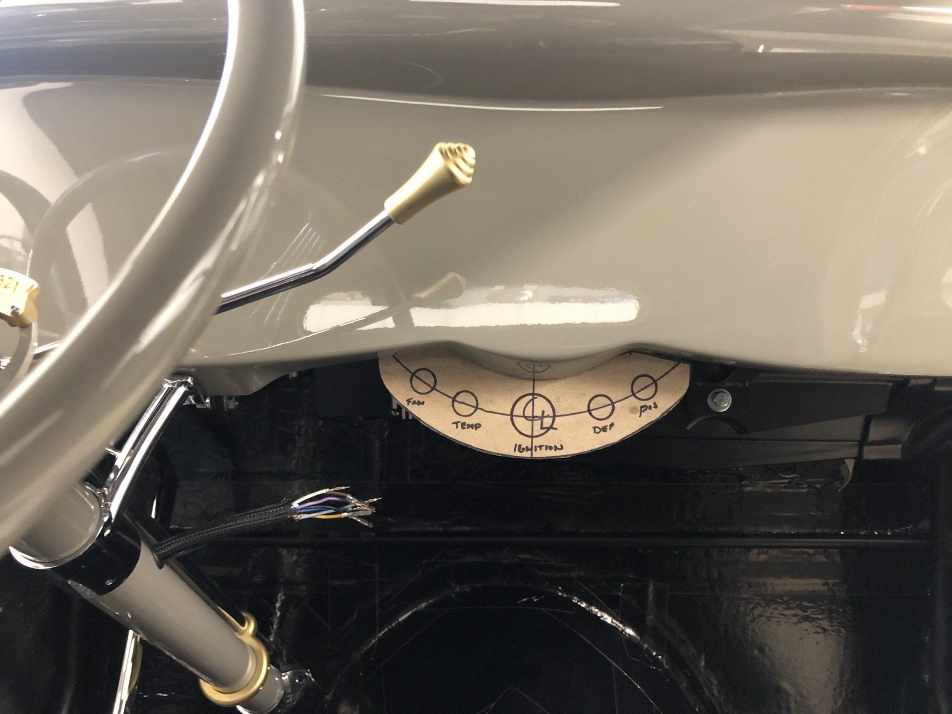 A close up of a steering wheel and dashboard of a car