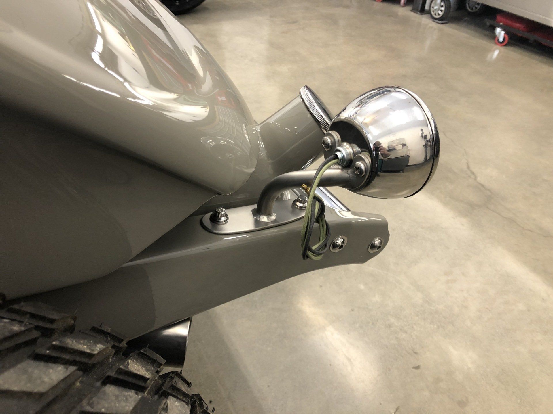 A close up of a motorcycle with a light attached to it.