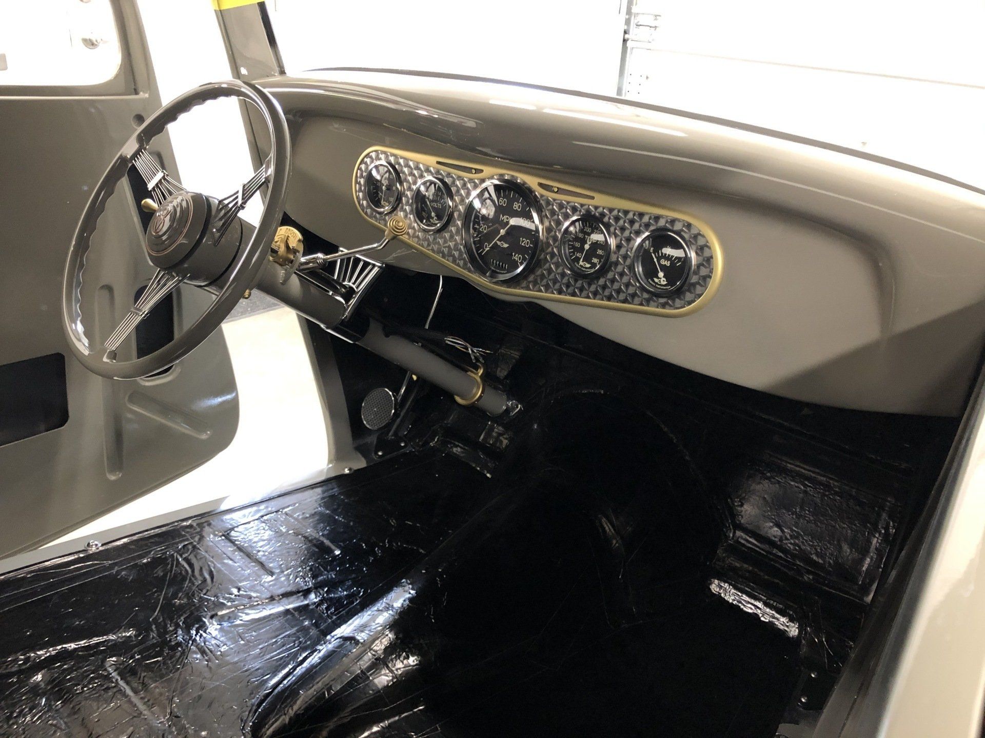The interior of a car with a steering wheel and dashboard.