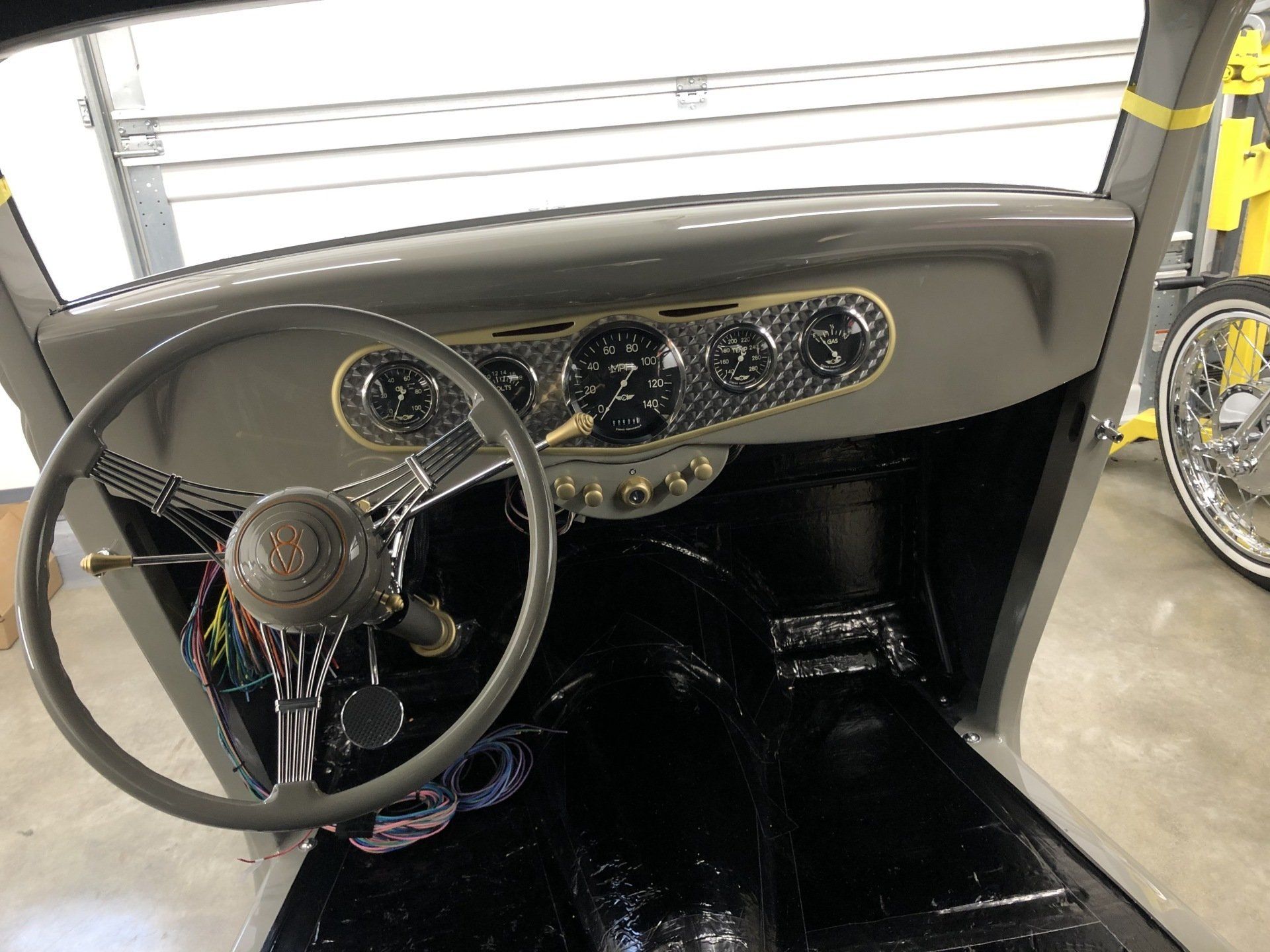 The inside of a car with a steering wheel and dashboard.