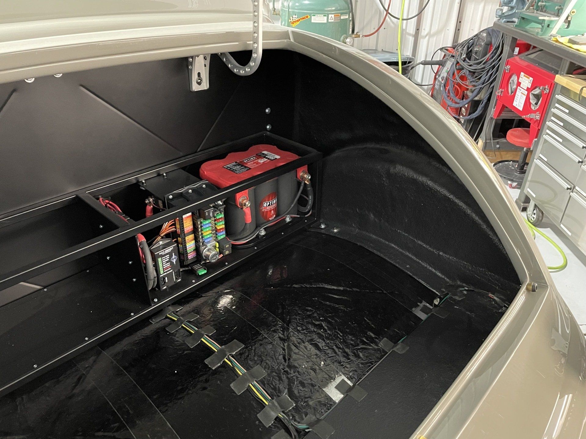 The trunk of a car with a red box in it