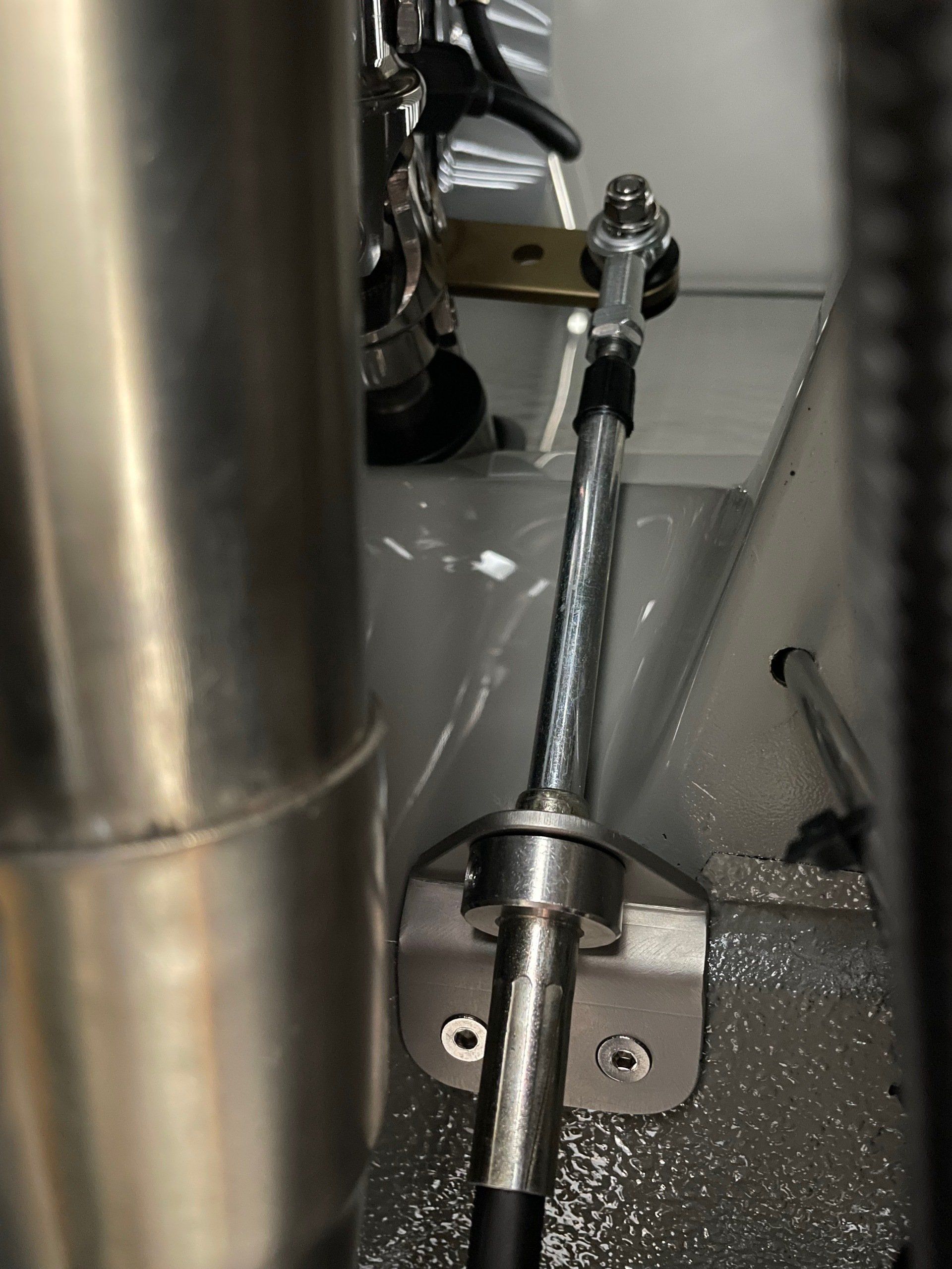 A close up of a metal pipe with a hose attached to it