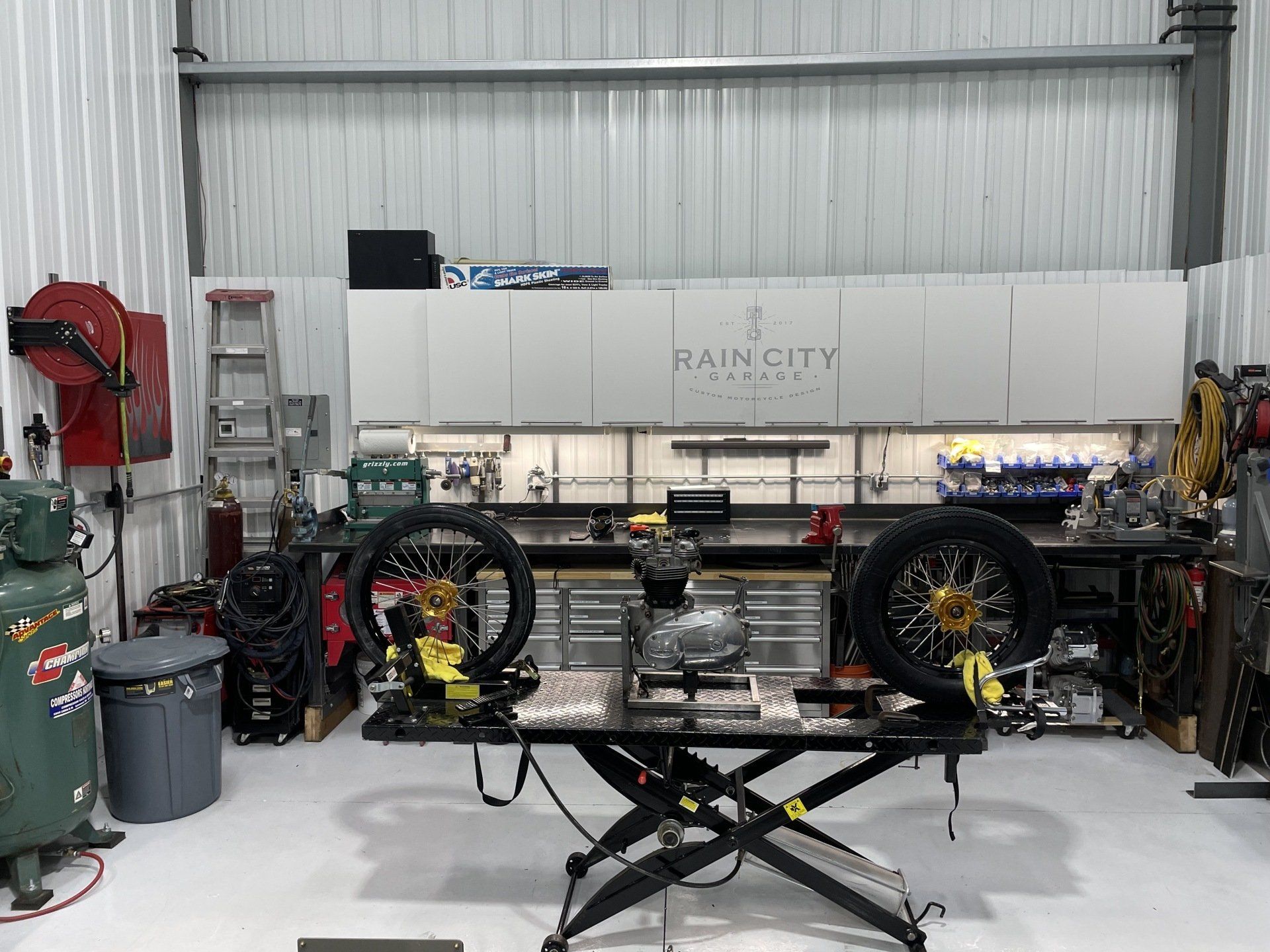 A motorcycle is being worked on in a garage.