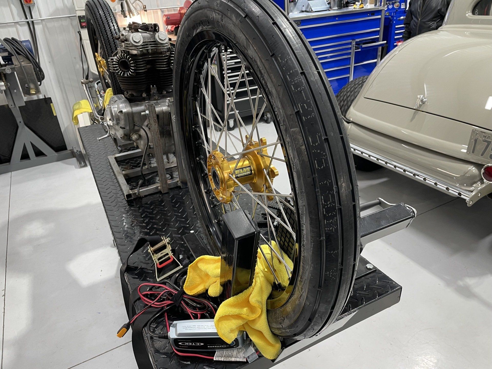 A close up of a tire on a stand in a garage