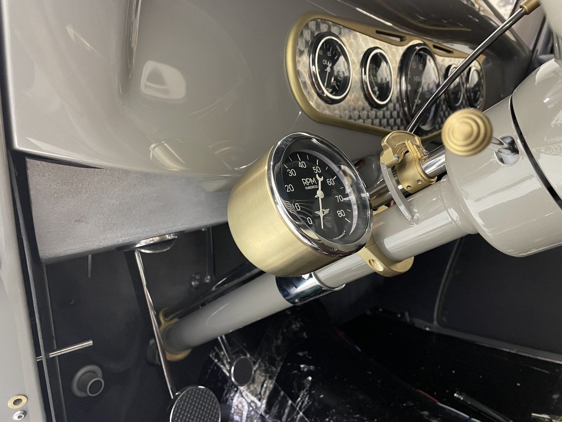 A close up of a gauge on the steering wheel of a car