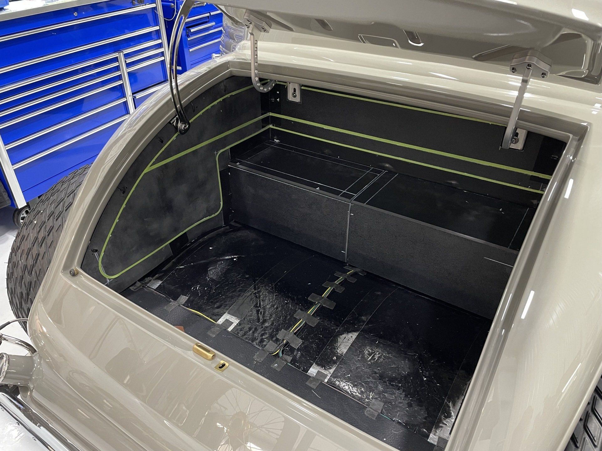 The trunk of a car with the hood open