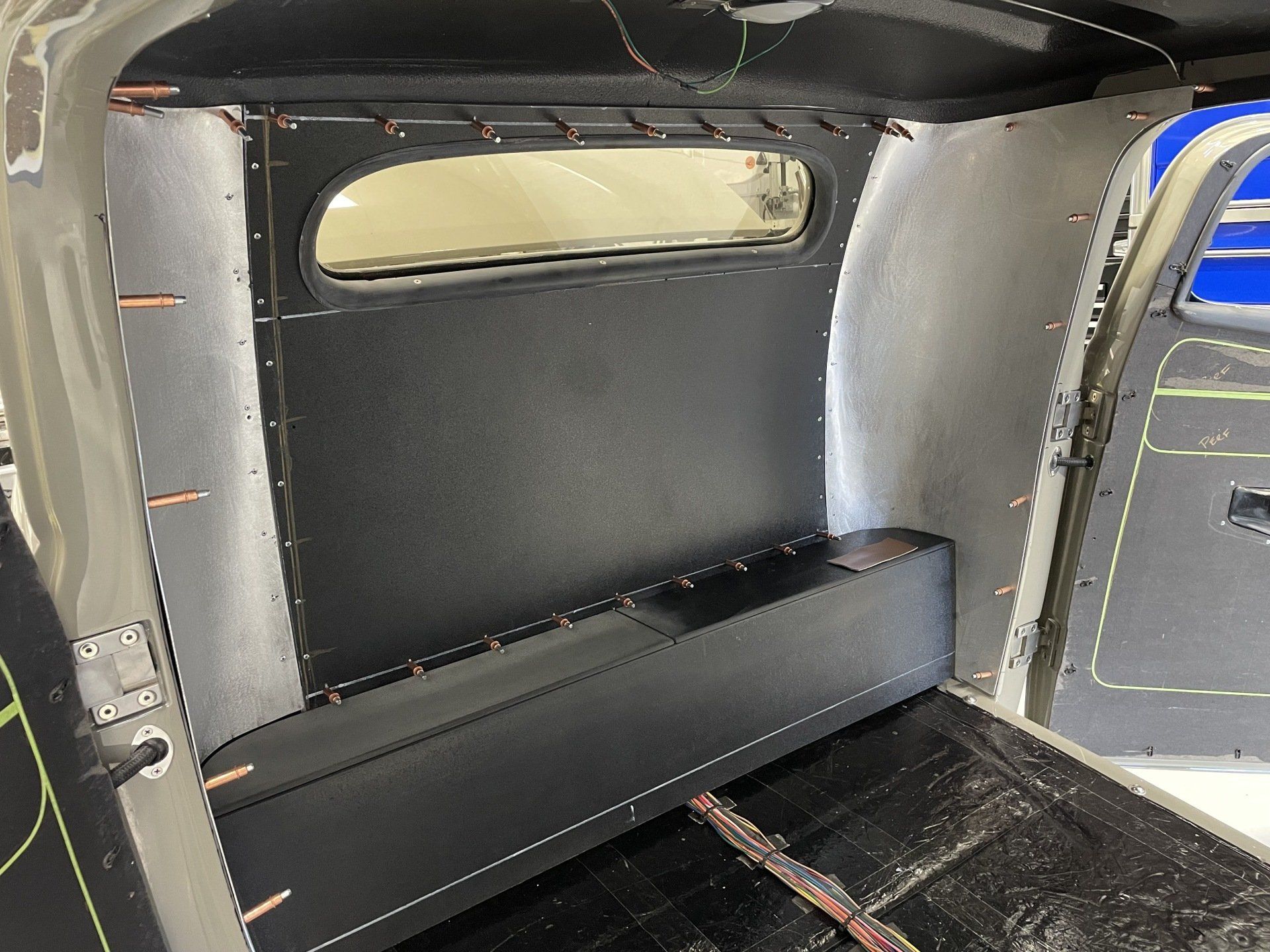 The inside of a car with a black seat and a window