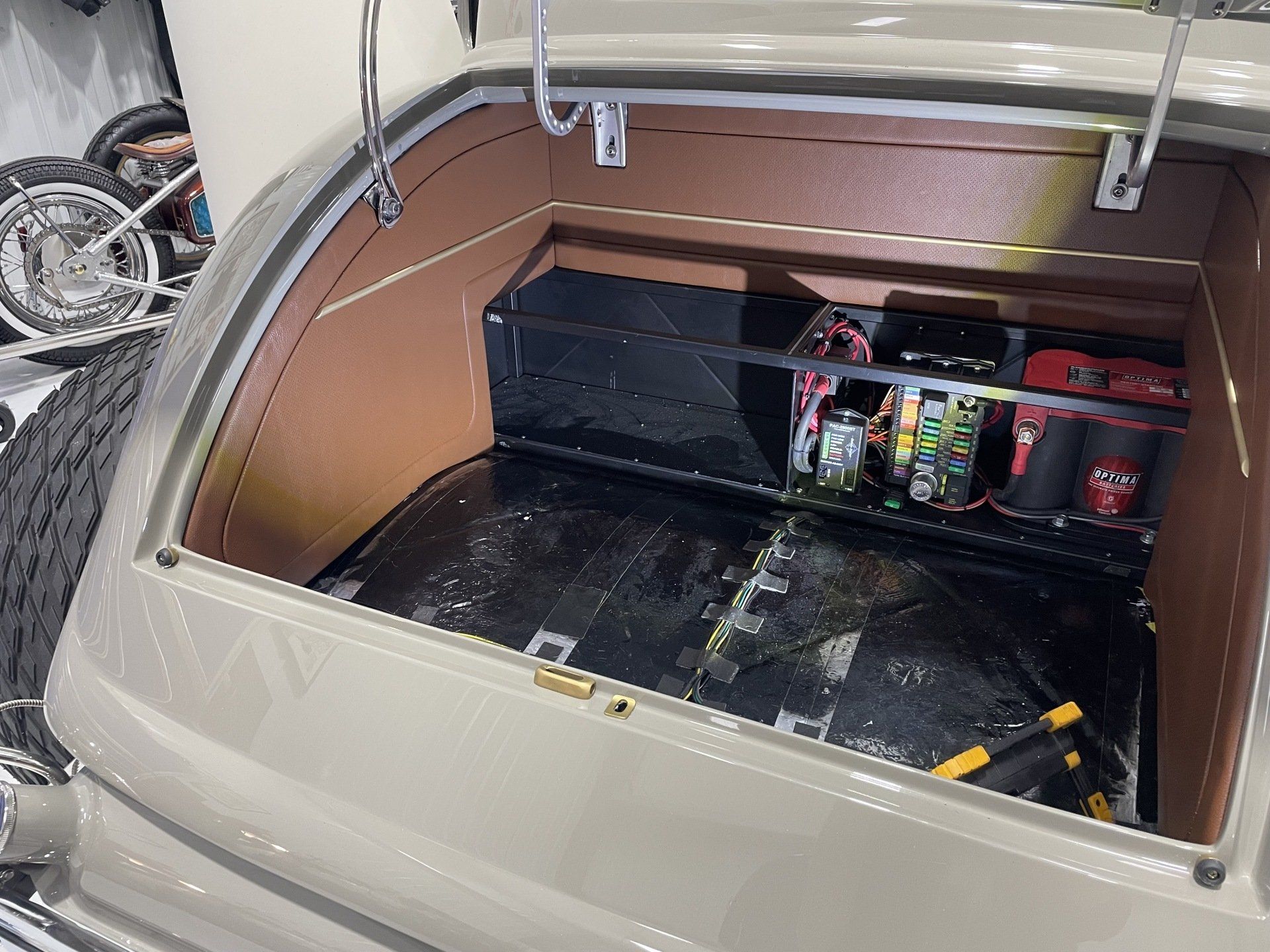 The trunk of a car is open and filled with various items.