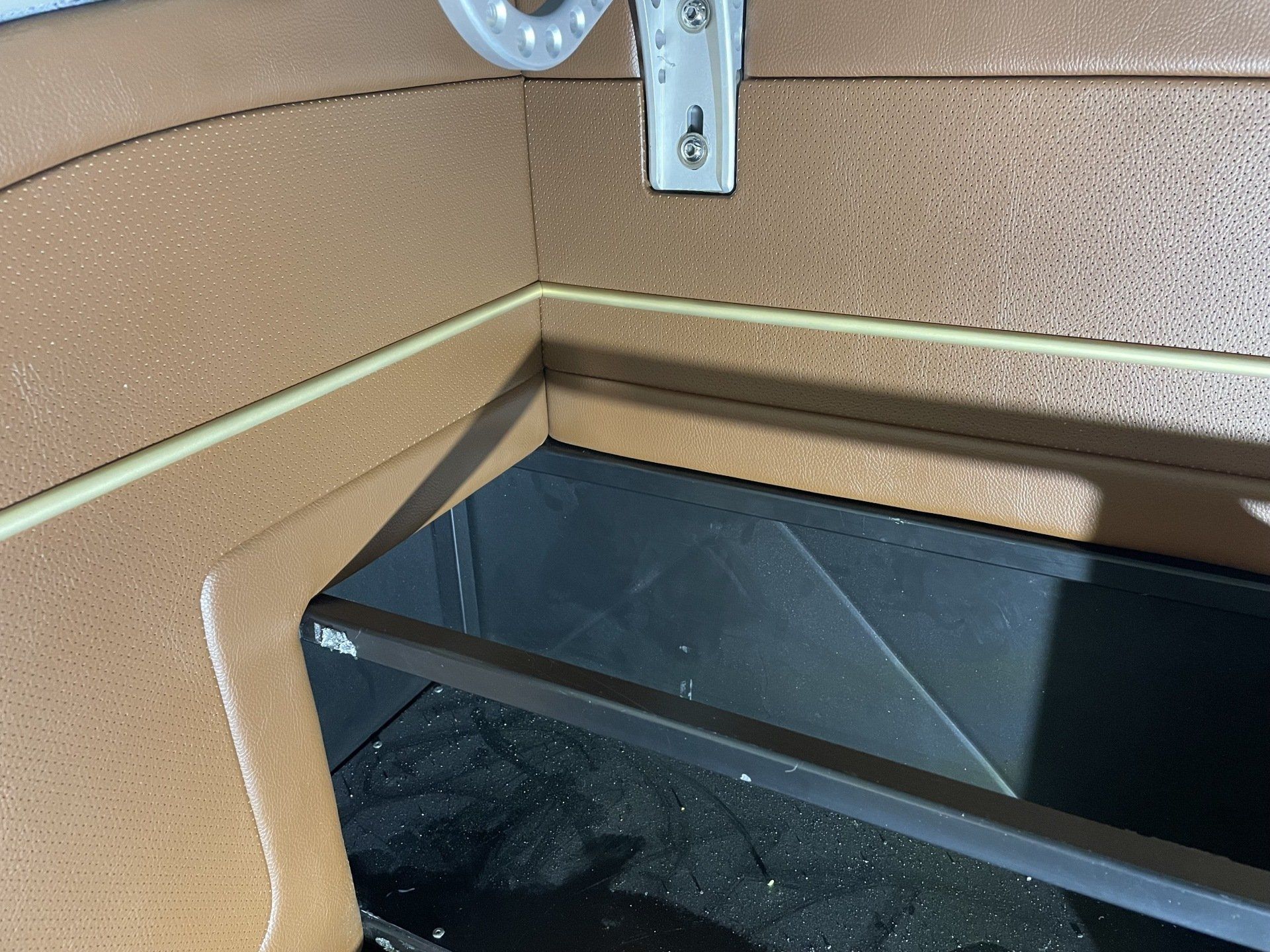 A corner of a room with a shelf in it