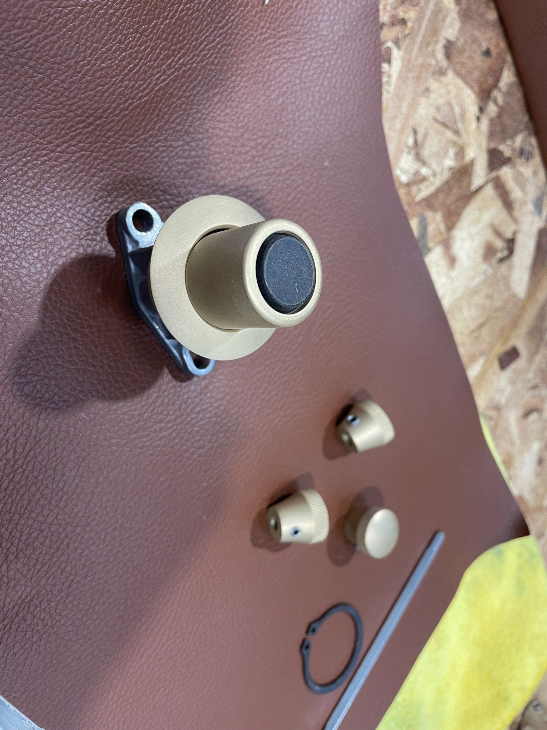 A close up of a brass object on a brown surface