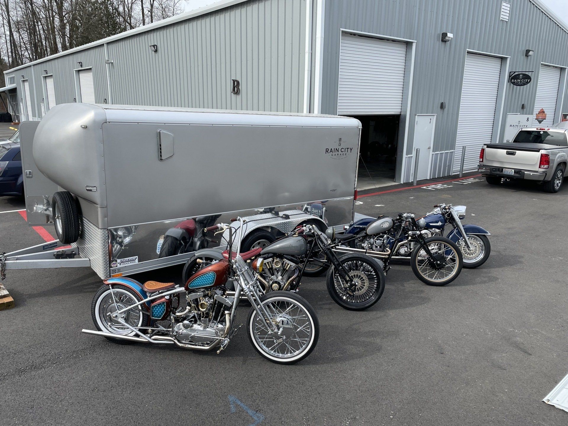 A group of motorcycles are parked in front of a building.