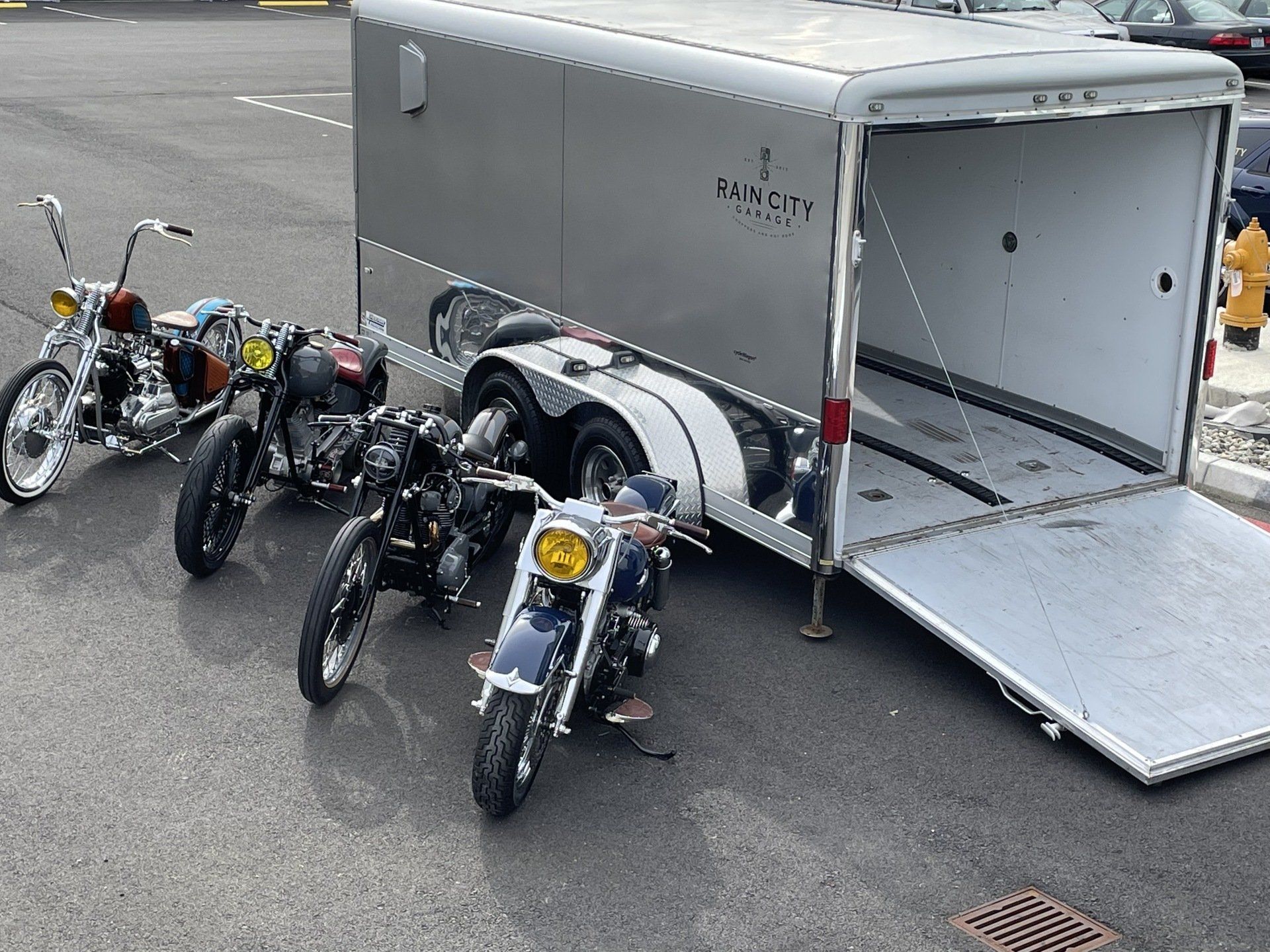 Several motorcycles are parked in front of a trailer that says palmetto