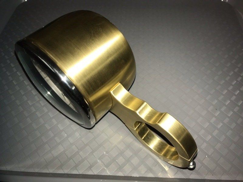 A close up of a brass object on a table