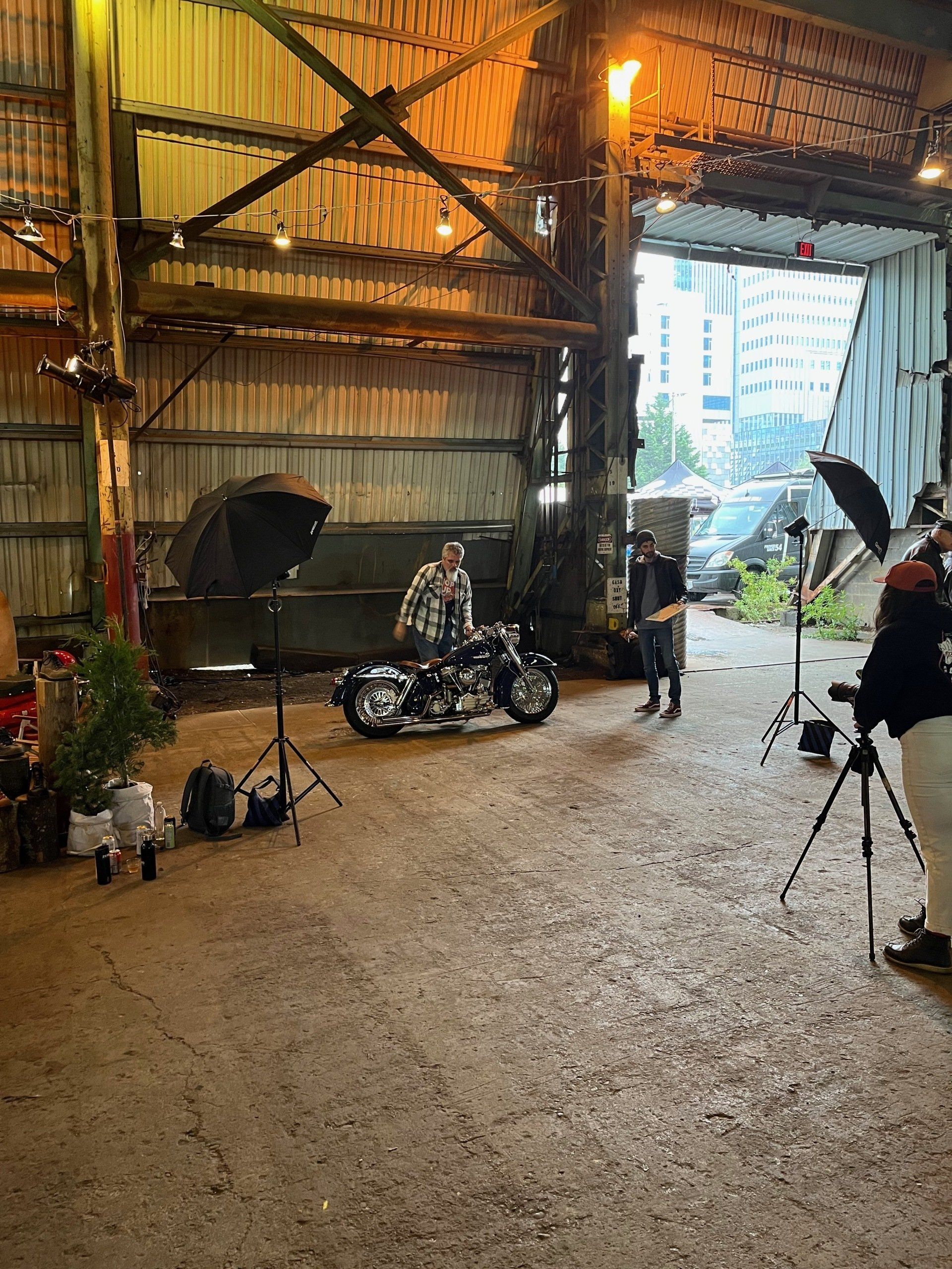A man is riding a motorcycle in a garage.