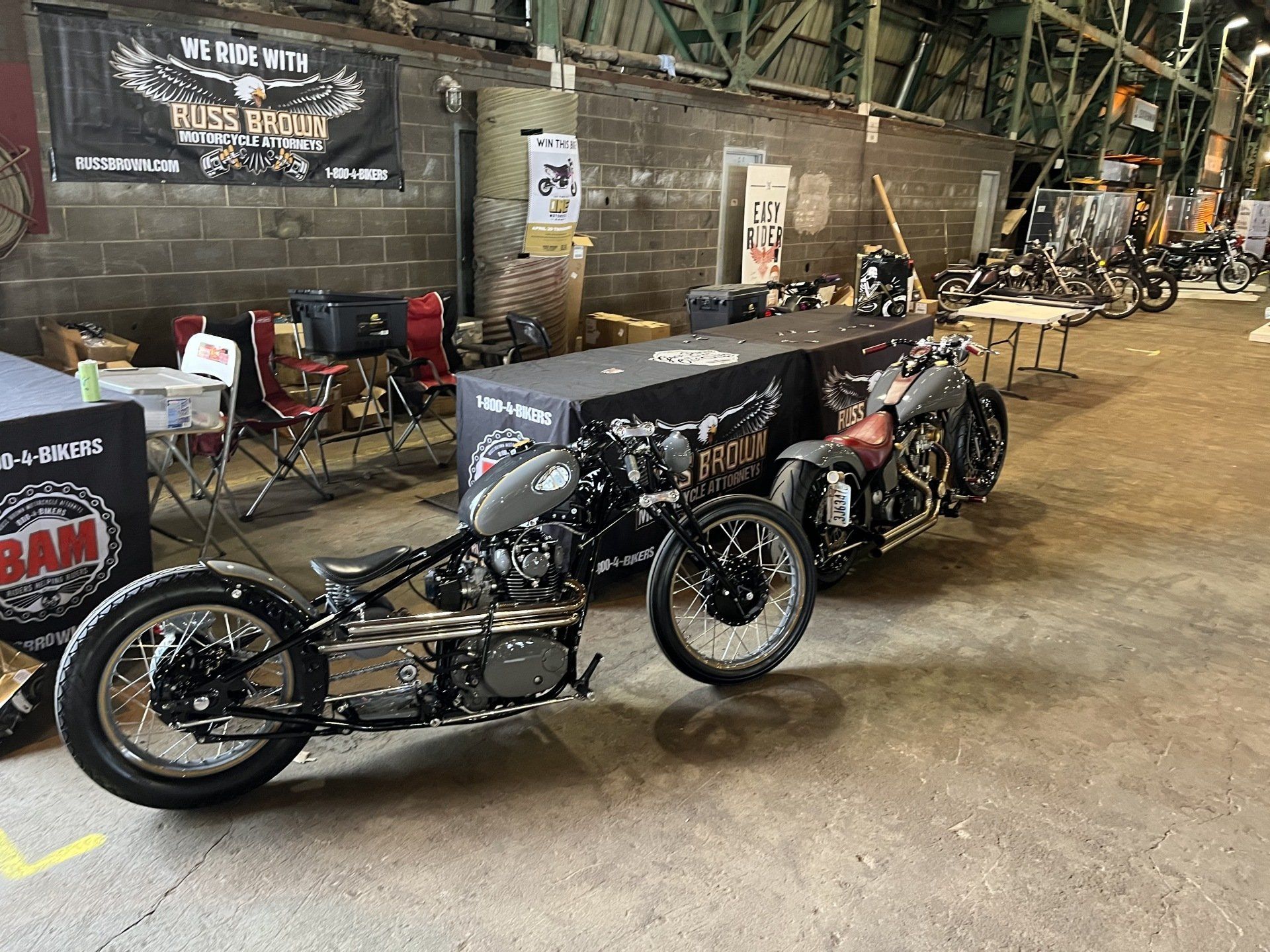 Two motorcycles are parked next to each other in a garage.