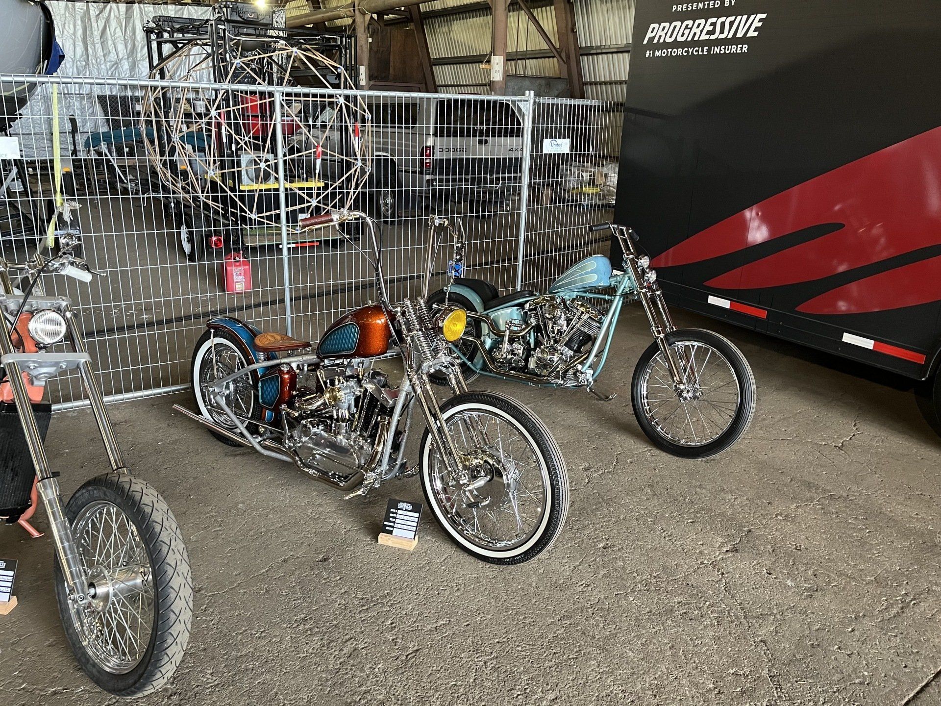 Three motorcycles are parked next to each other in a garage.