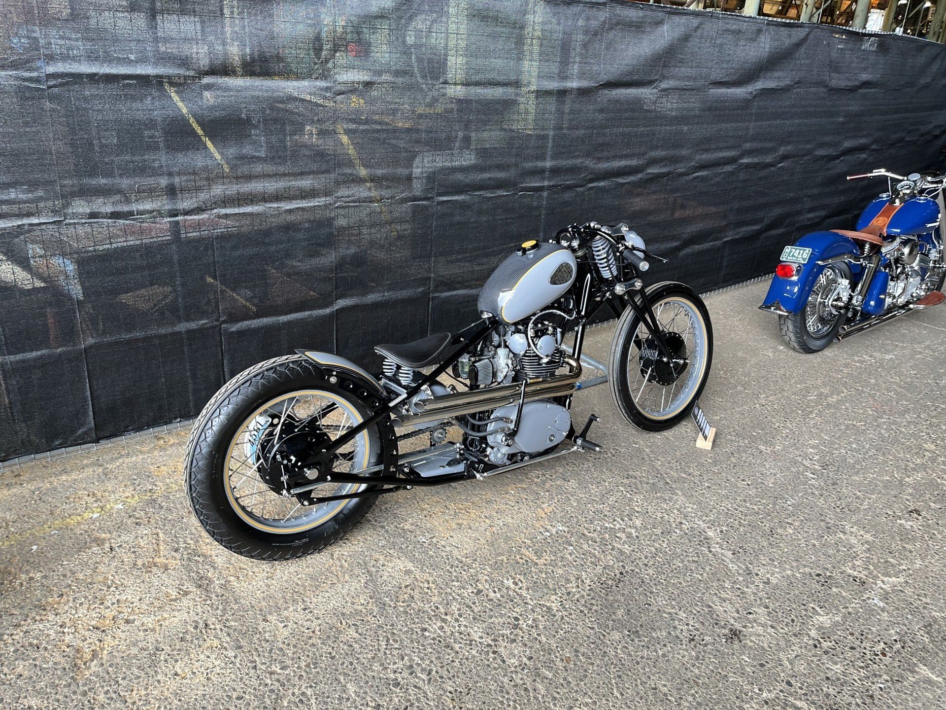 Two motorcycles are parked next to each other on the side of the road.