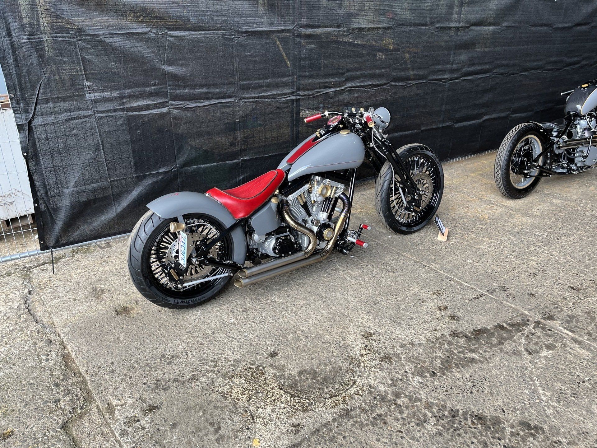 Two motorcycles are parked next to each other in a parking lot.