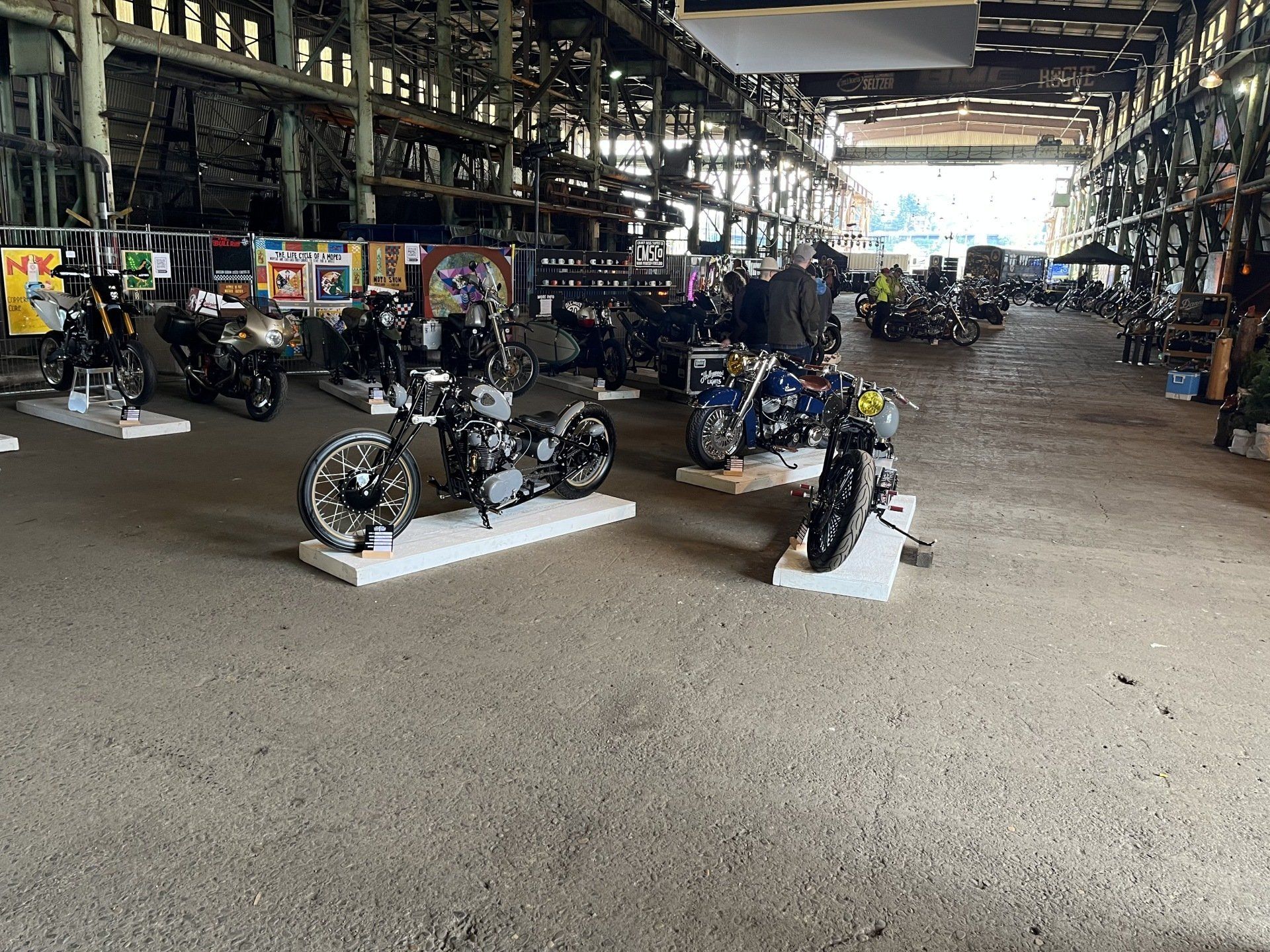 A large warehouse filled with motorcycles on display.