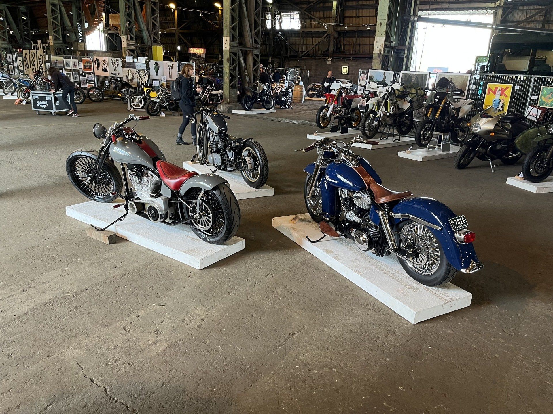 A warehouse filled with lots of motorcycles on display.