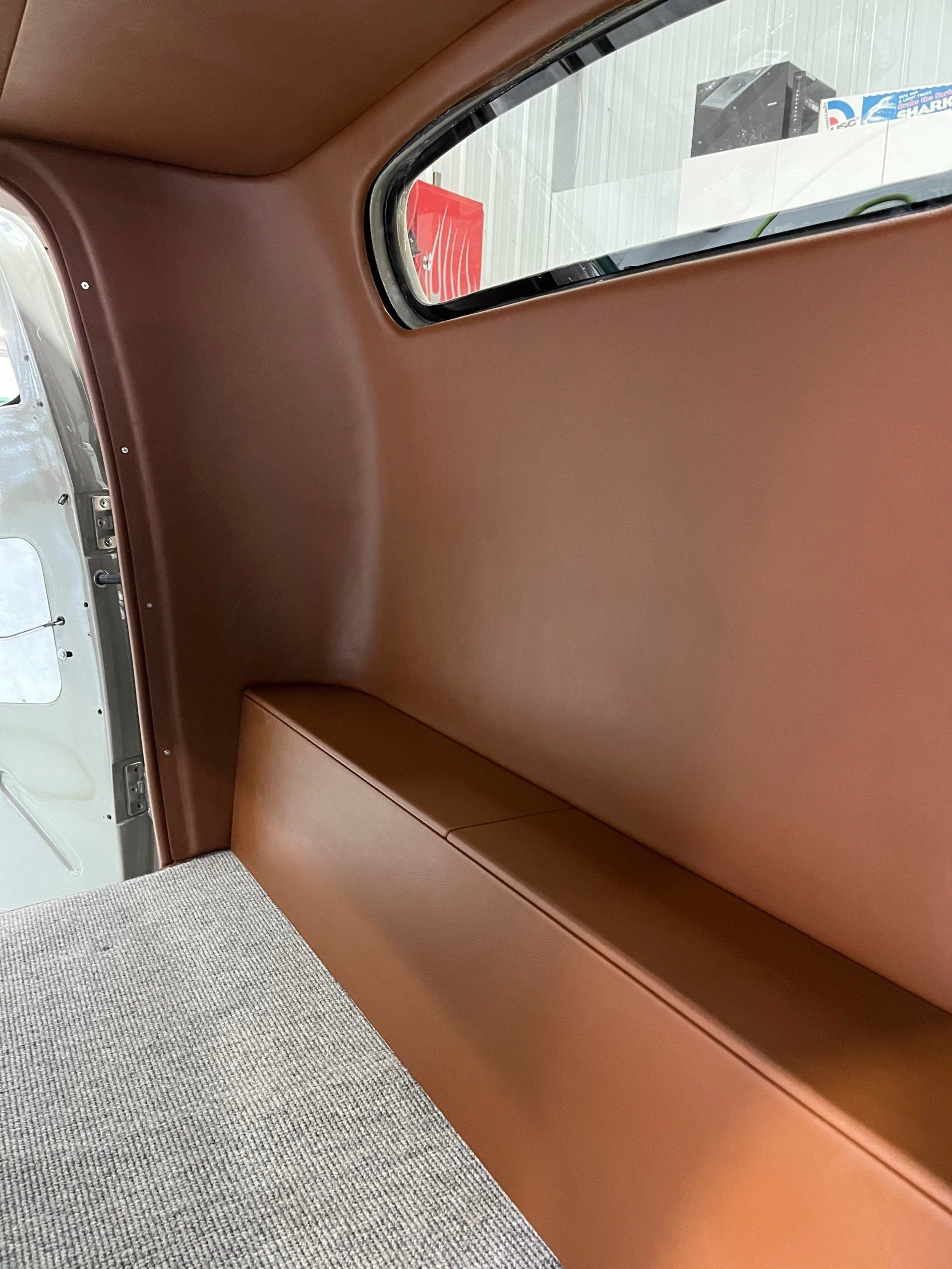 A close up of a brown leather seat in a car.