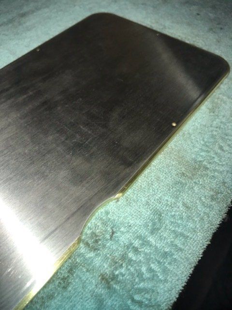 A piece of metal is laying on a blue cloth