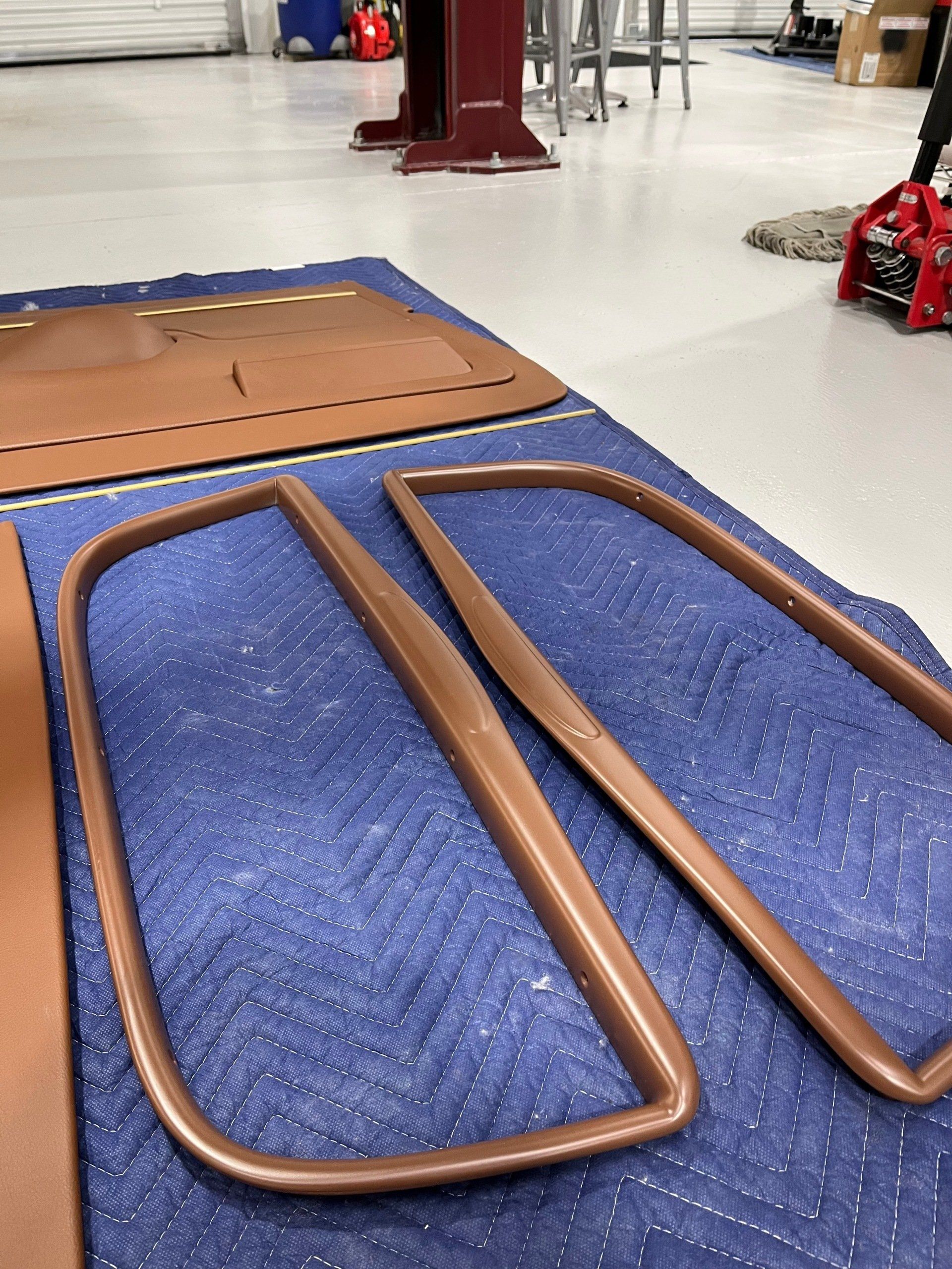 A pair of brown frames are laying on a blue blanket