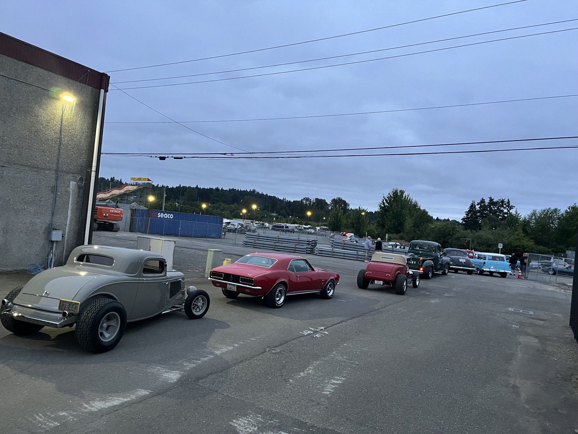 A row of cars are parked on the side of the road.