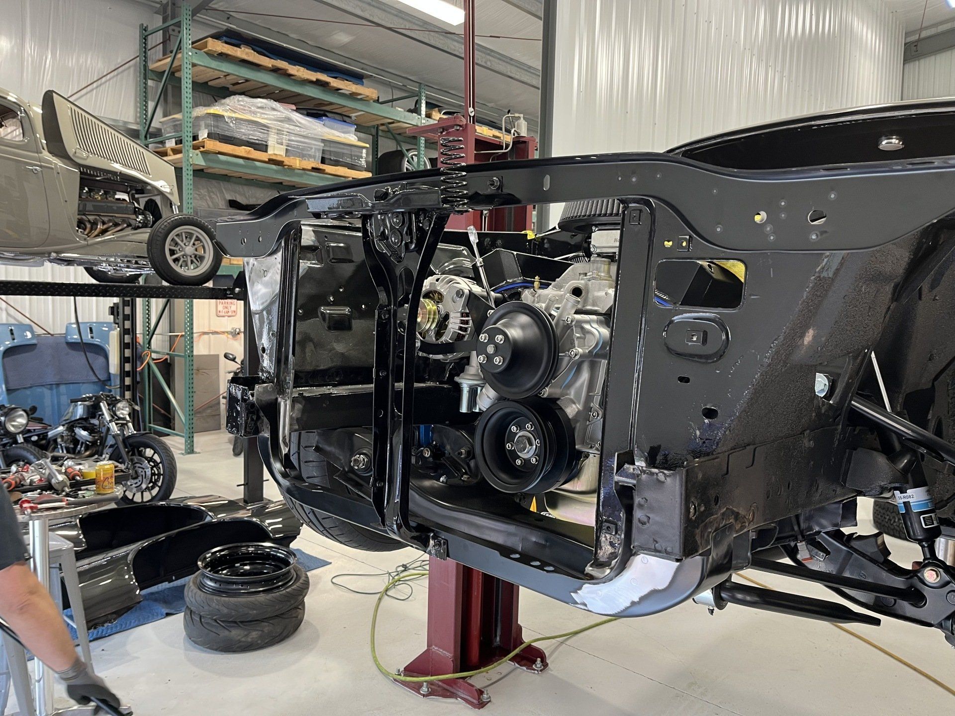 A man is working on a car in a garage.