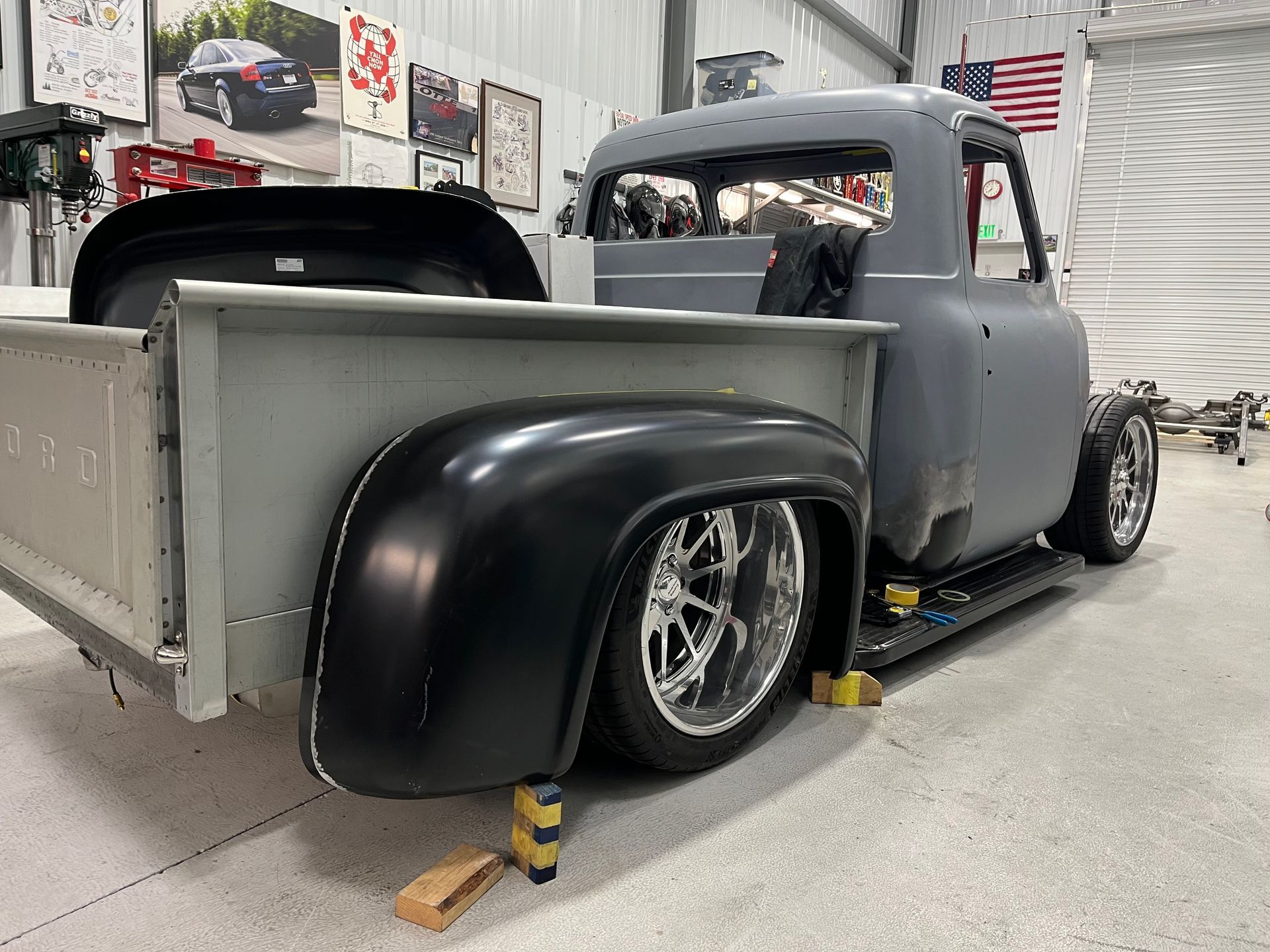 A truck is parked in a garage with a trailer attached to it.