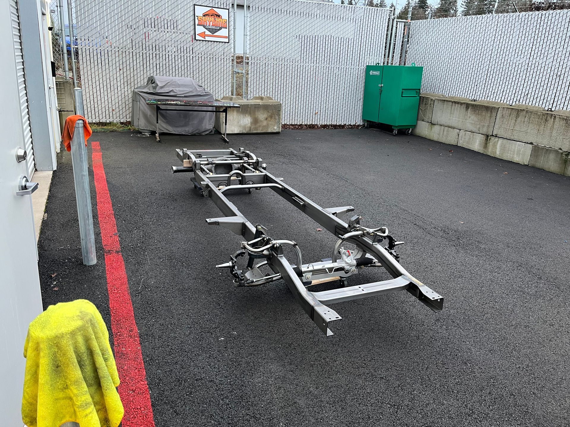 A metal frame is sitting on the ground in a parking lot.