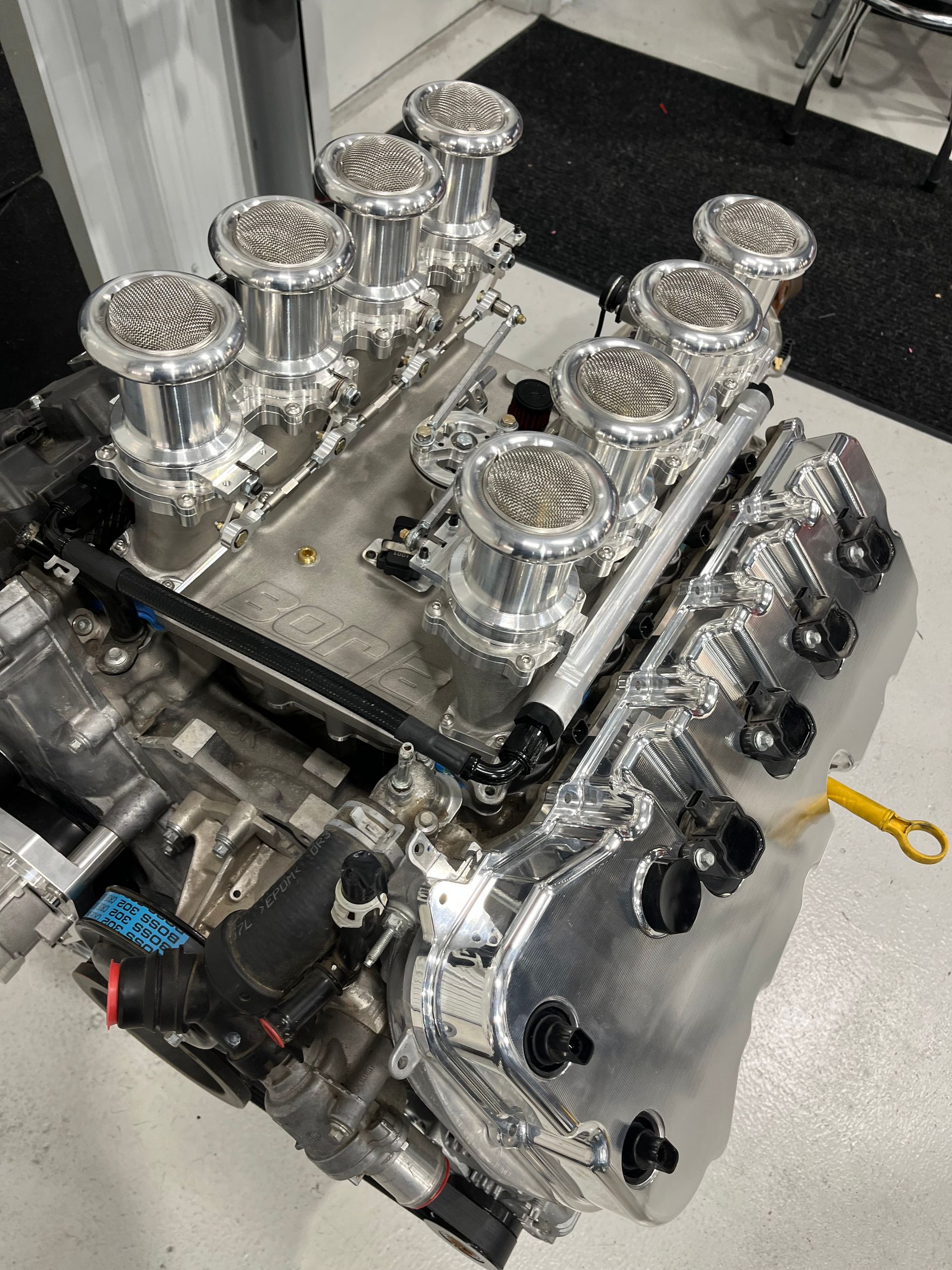 A large aluminum engine is sitting on the floor in a room.
