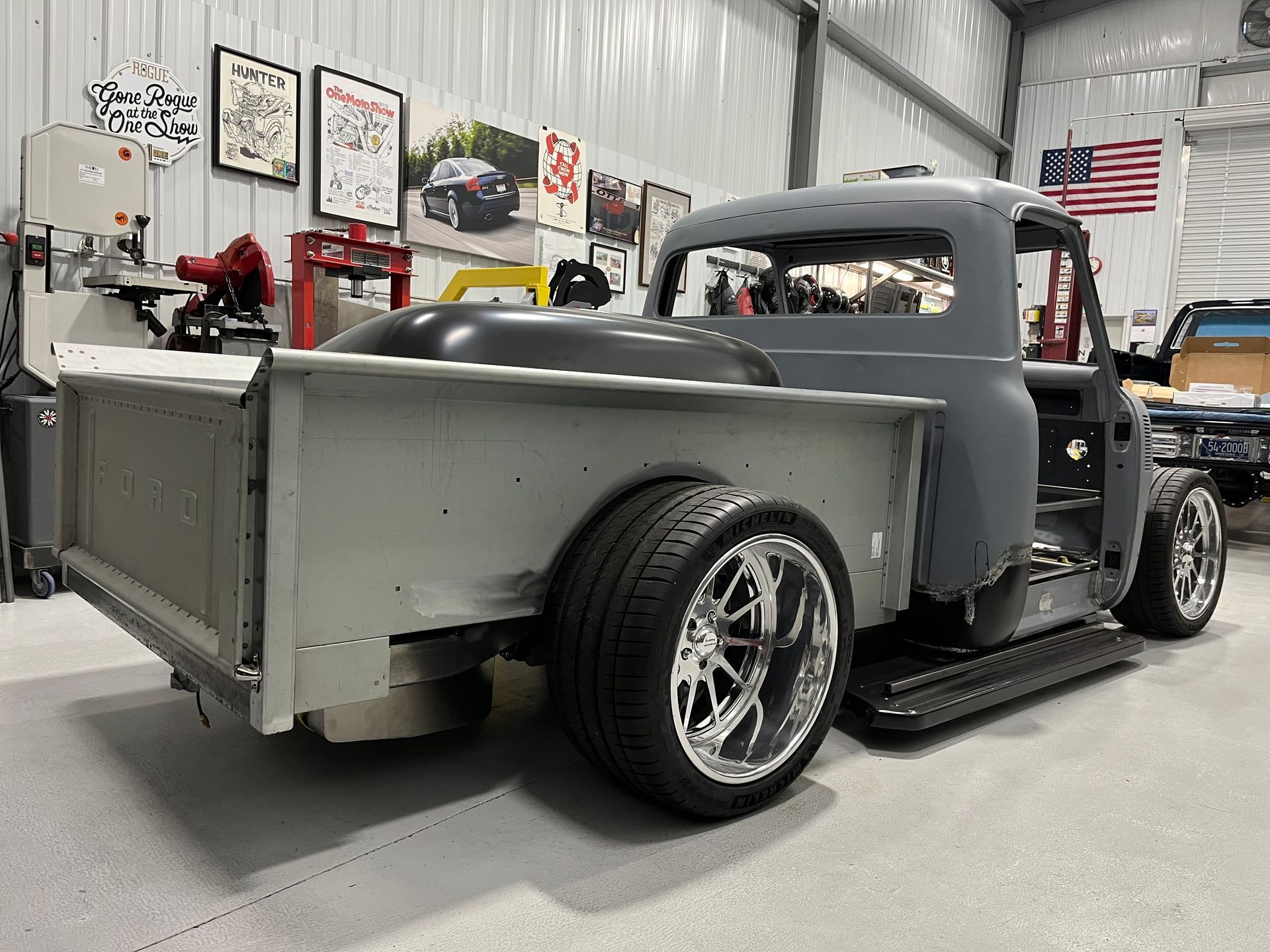 A gray truck is sitting in a garage.