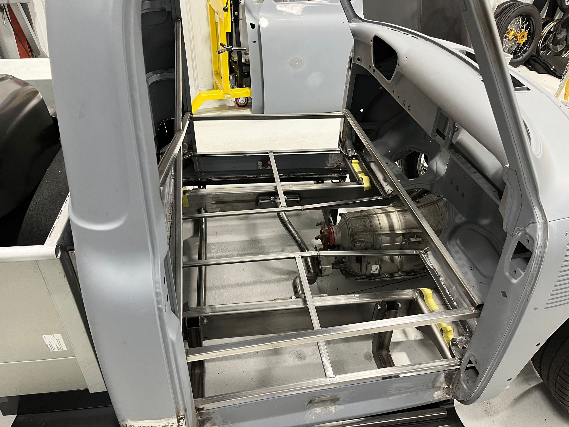 A truck is being built with a stainless steel frame.