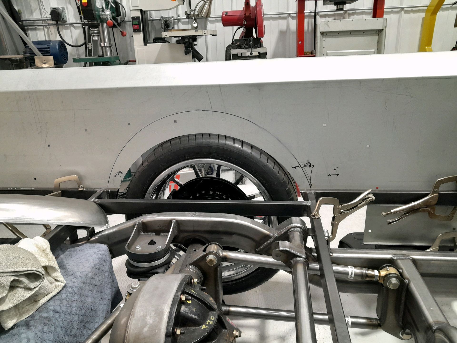 A car is being built in a garage with a tire on it