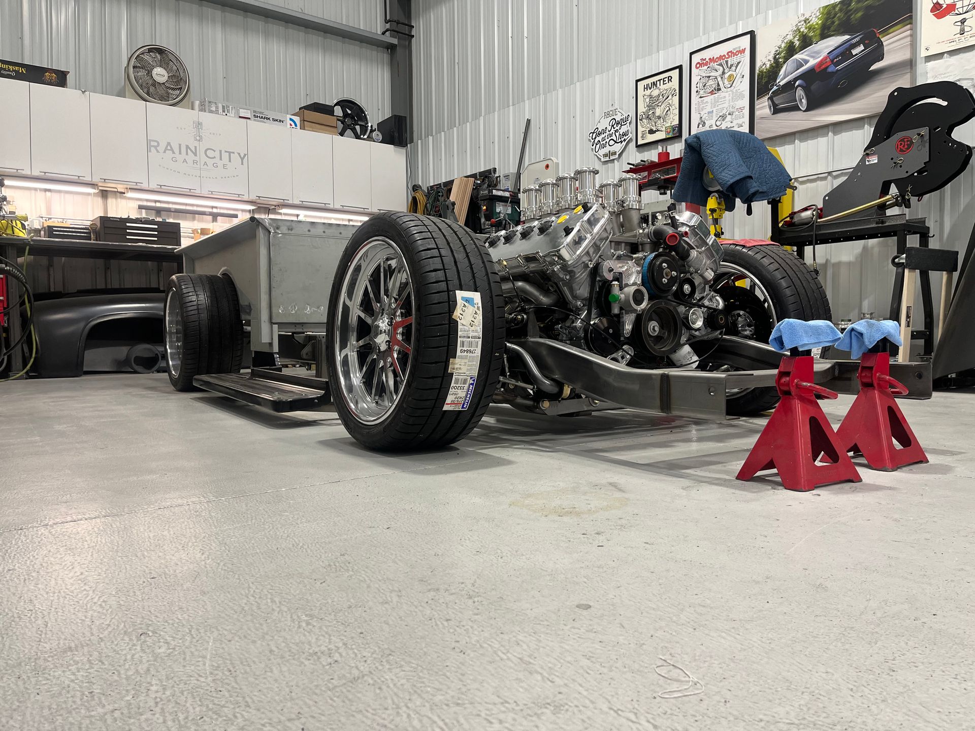 A car is being built in a garage.