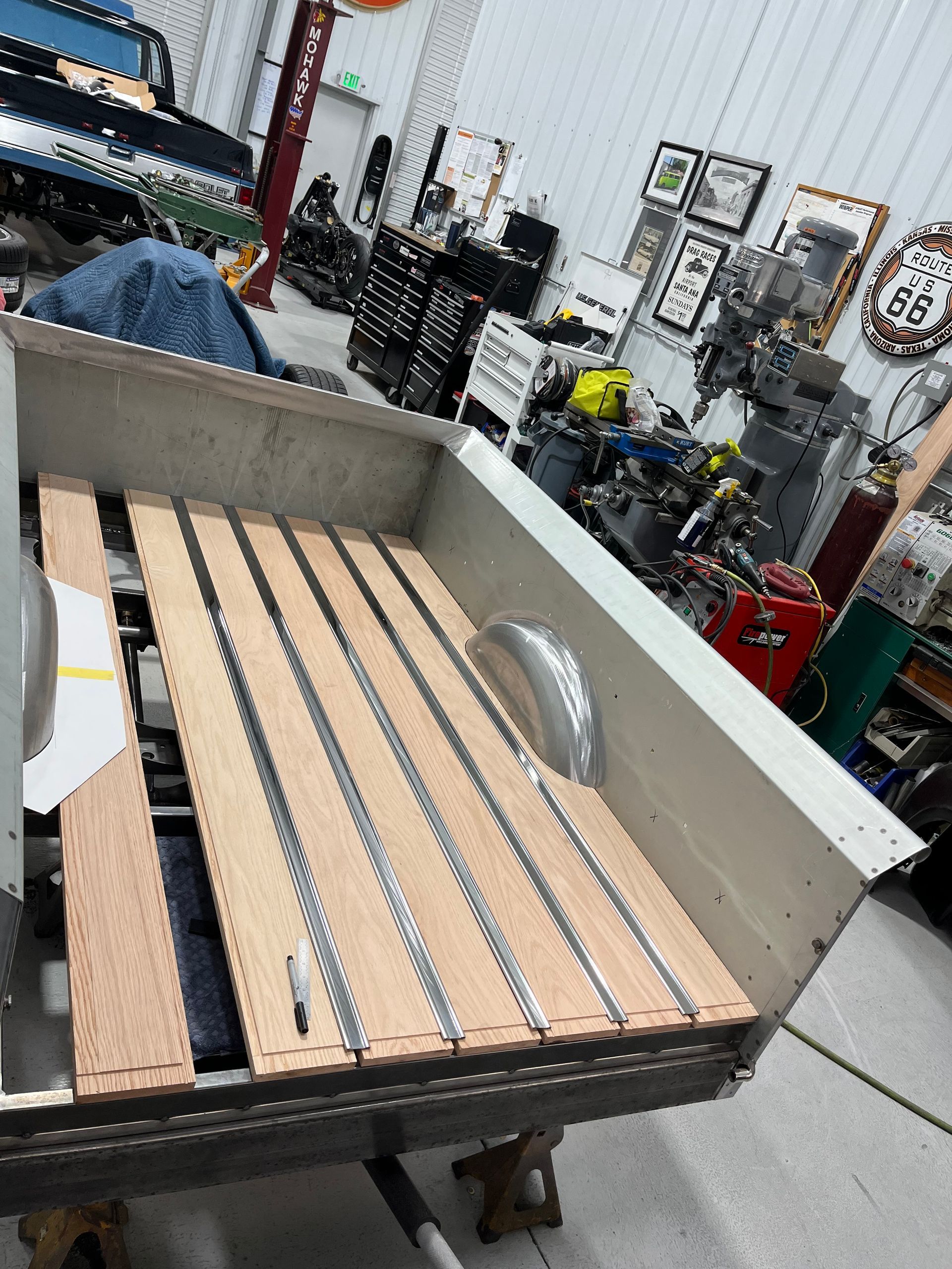 A pickup truck with a wooden bed in a garage