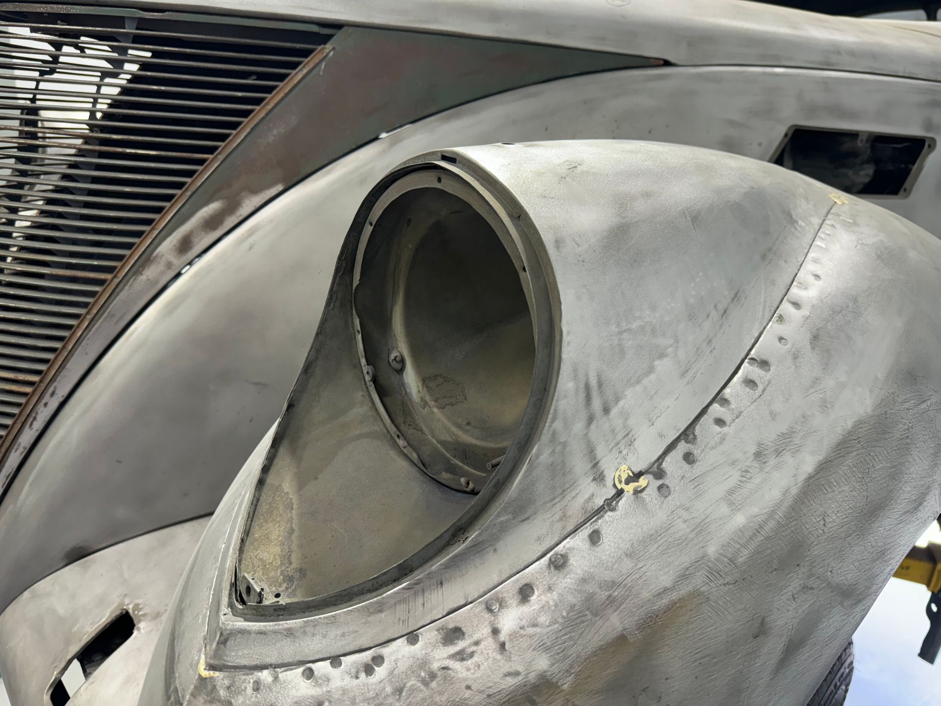 A close up of a car 's headlight and hood.