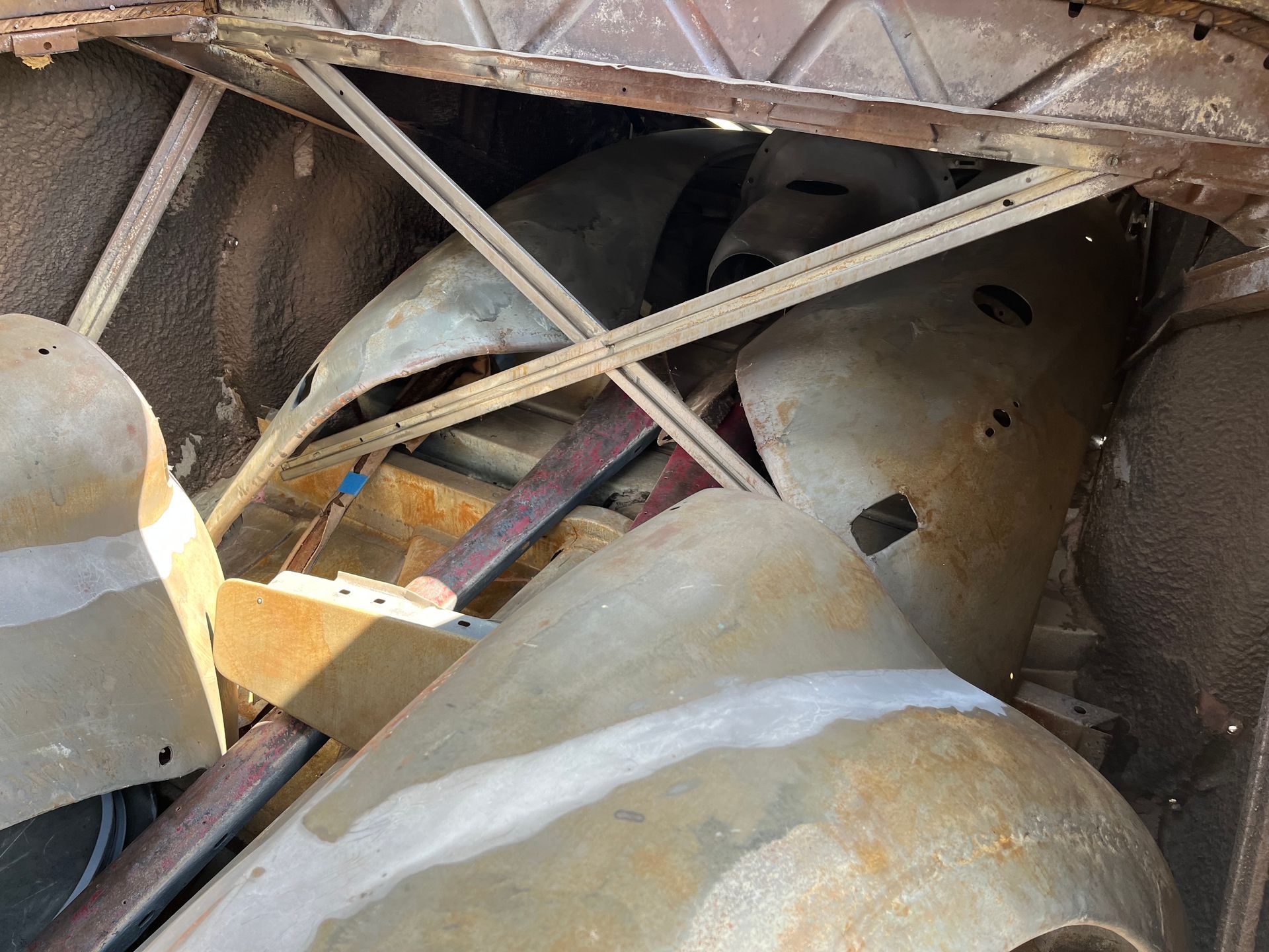 A pile of junk is sitting in the back of a car.