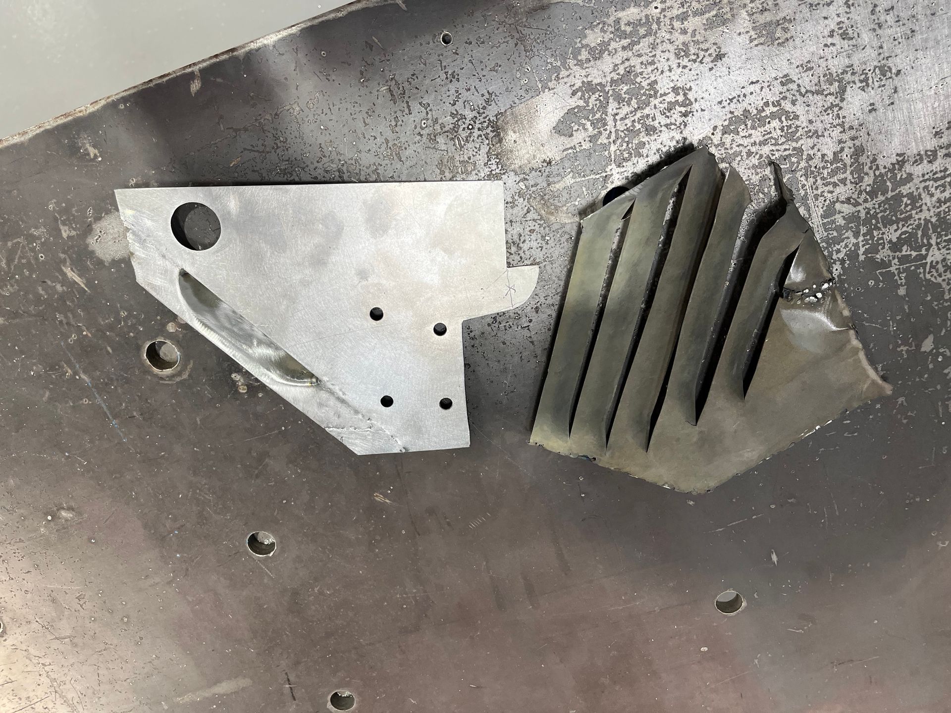 A piece of metal is sitting on top of a metal surface.