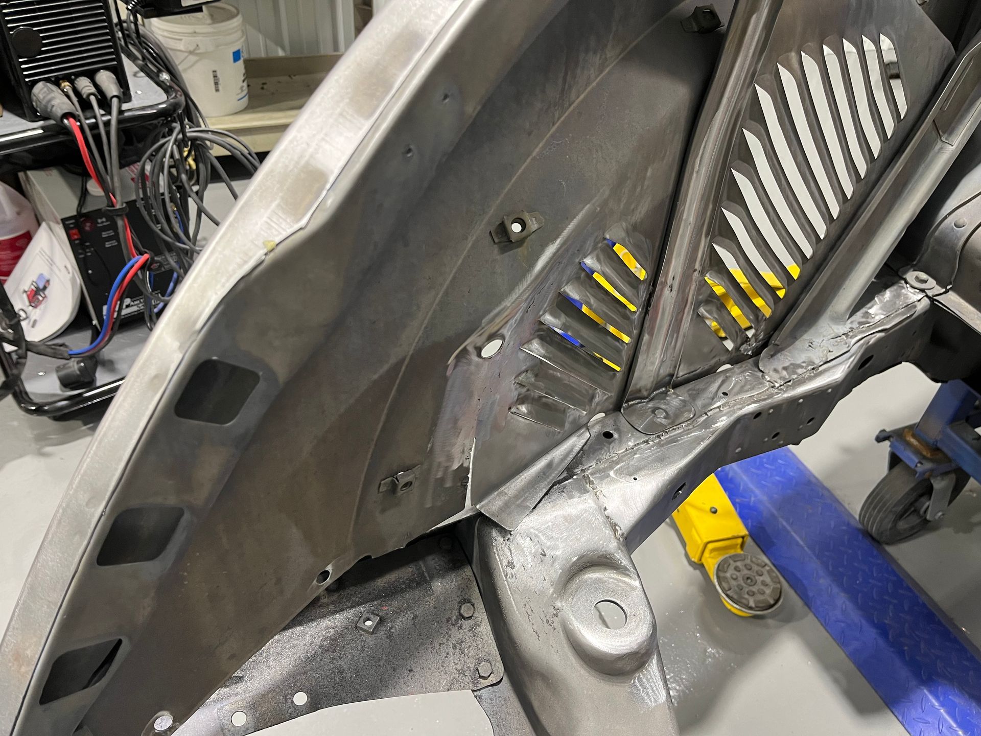 A piece of metal is sitting on a table in a garage.