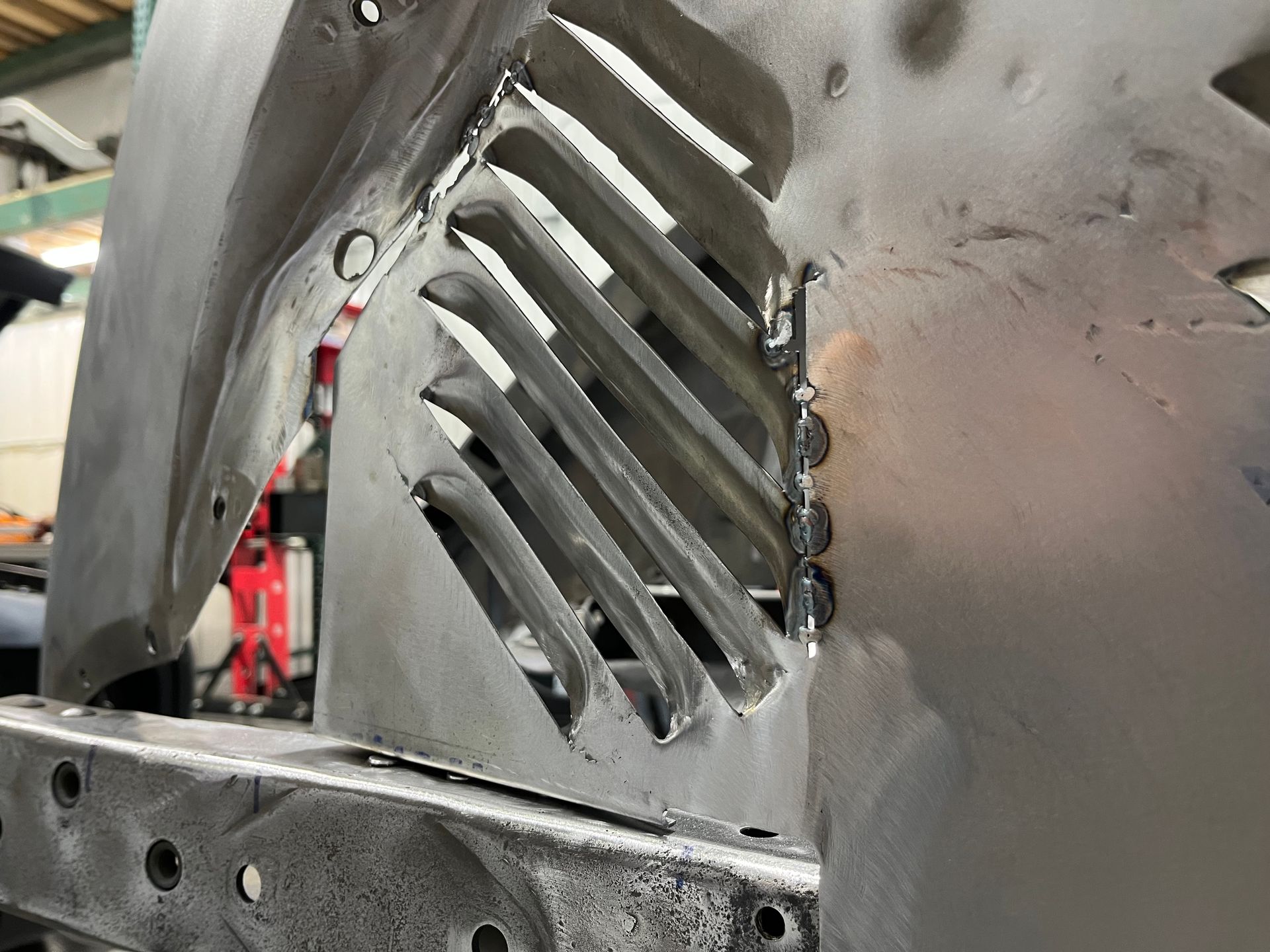 A close up of a piece of metal with holes in it.