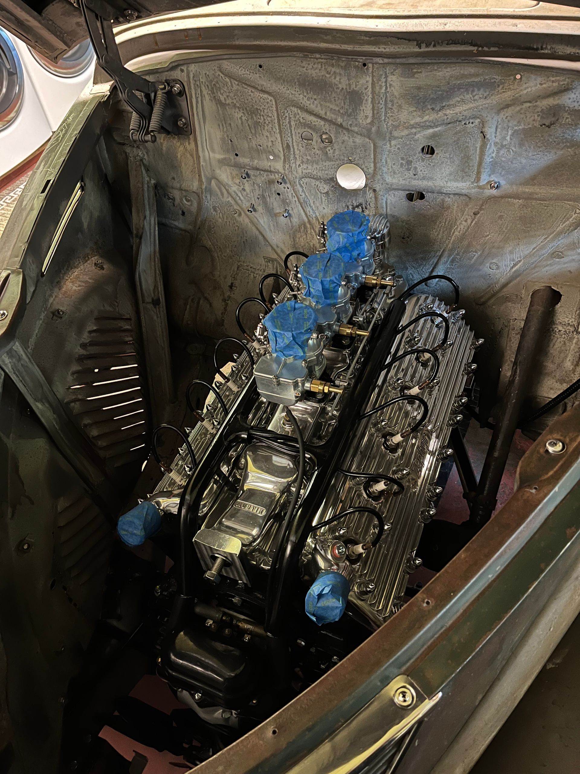 A close up of a car engine in the trunk.