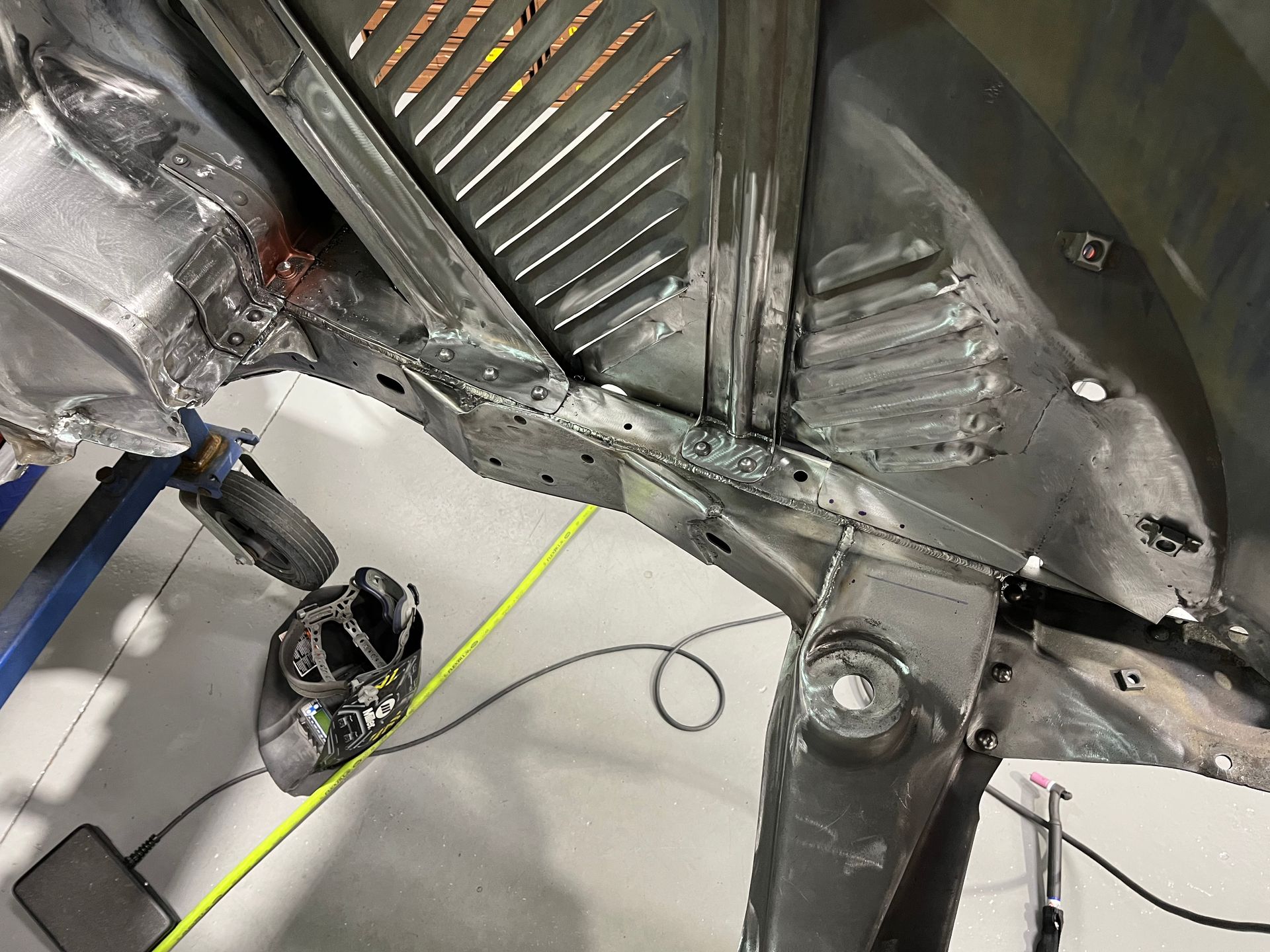 A car is being worked on in a garage.