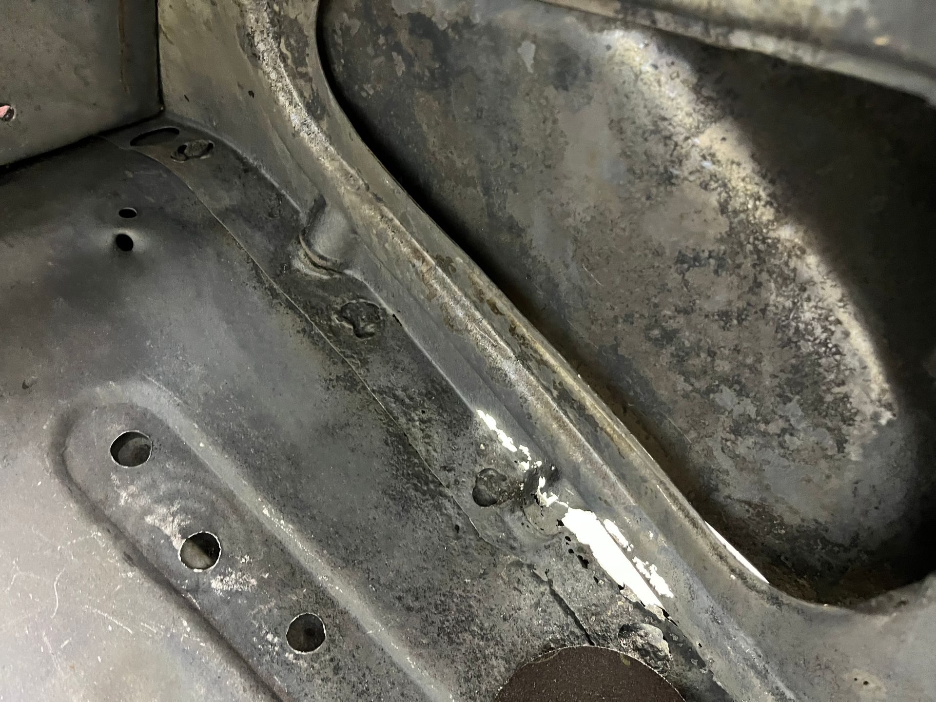 A close up of a metal object with holes in it.