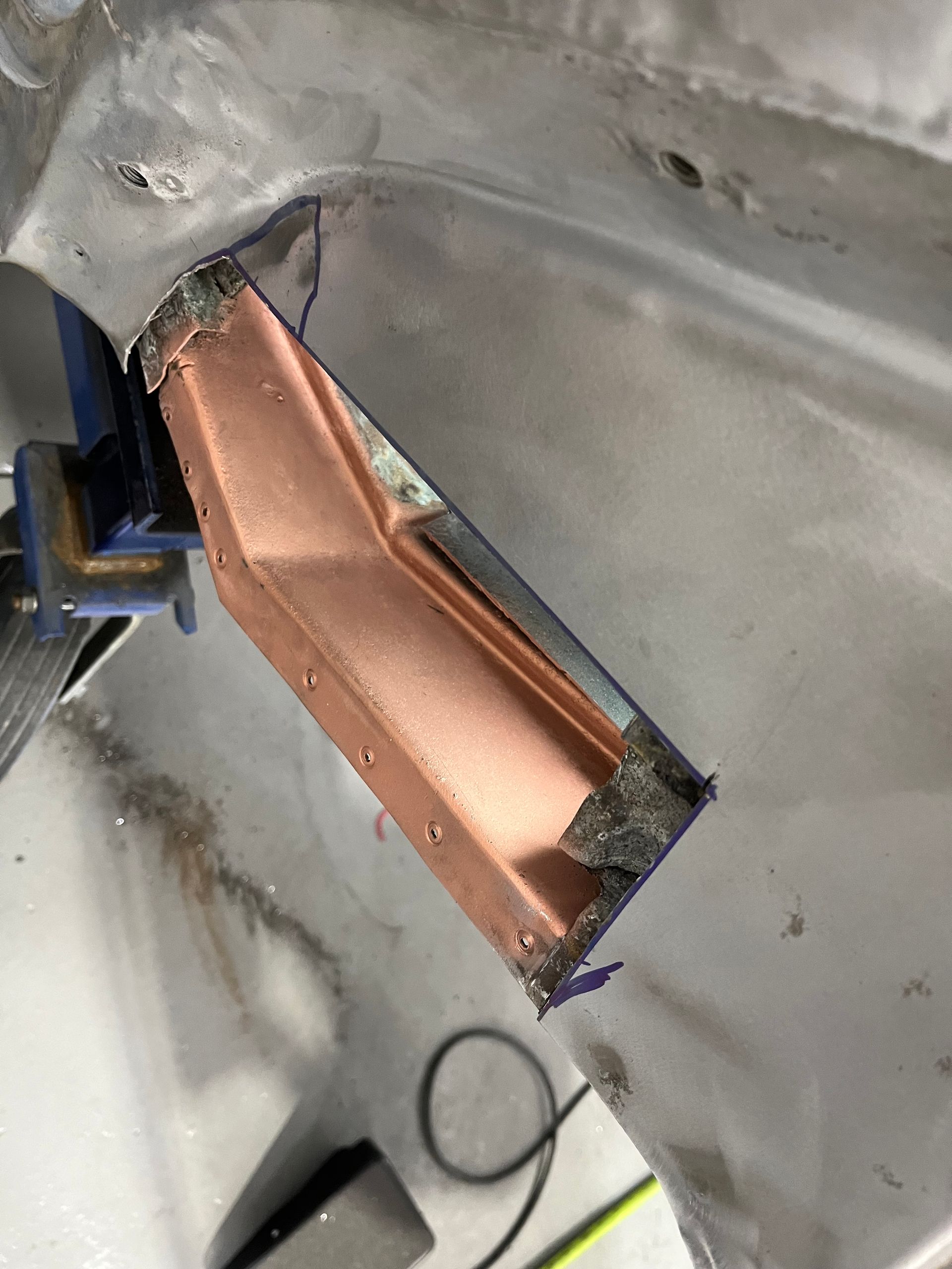 A piece of copper is sitting on top of a piece of metal.
