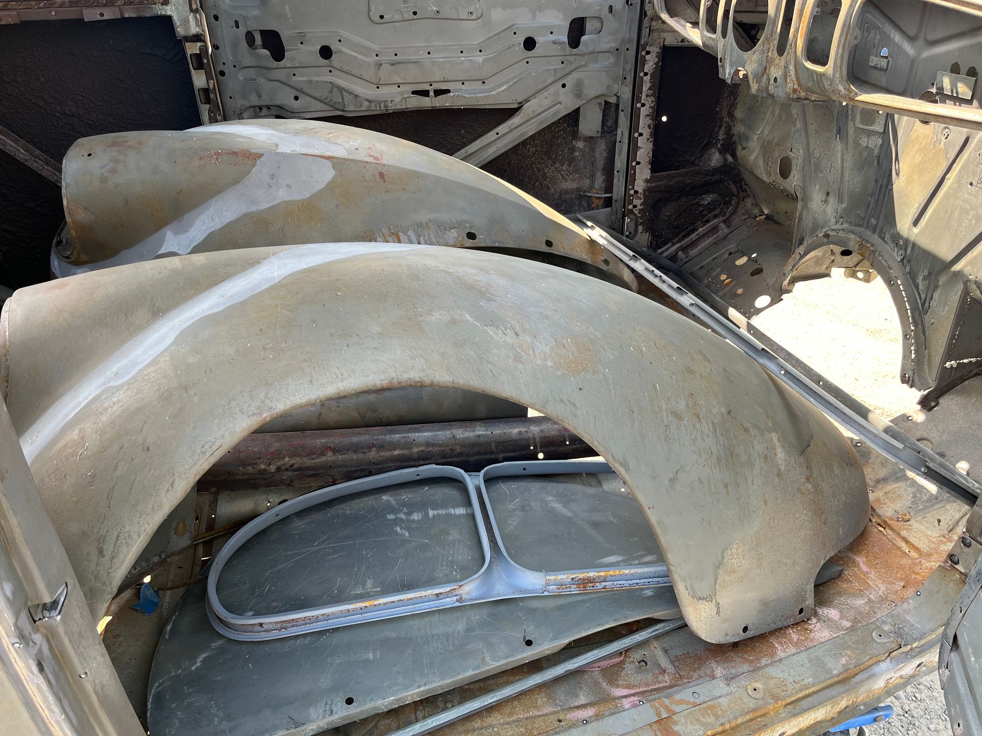 A bunch of old car parts are sitting on top of a table.